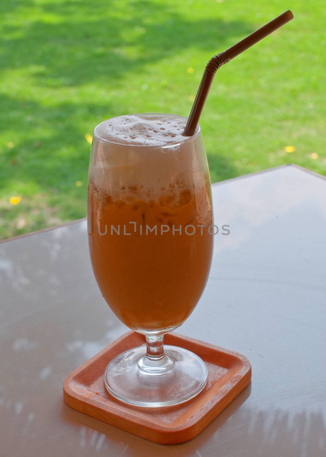 a glass of ice coffee on the table