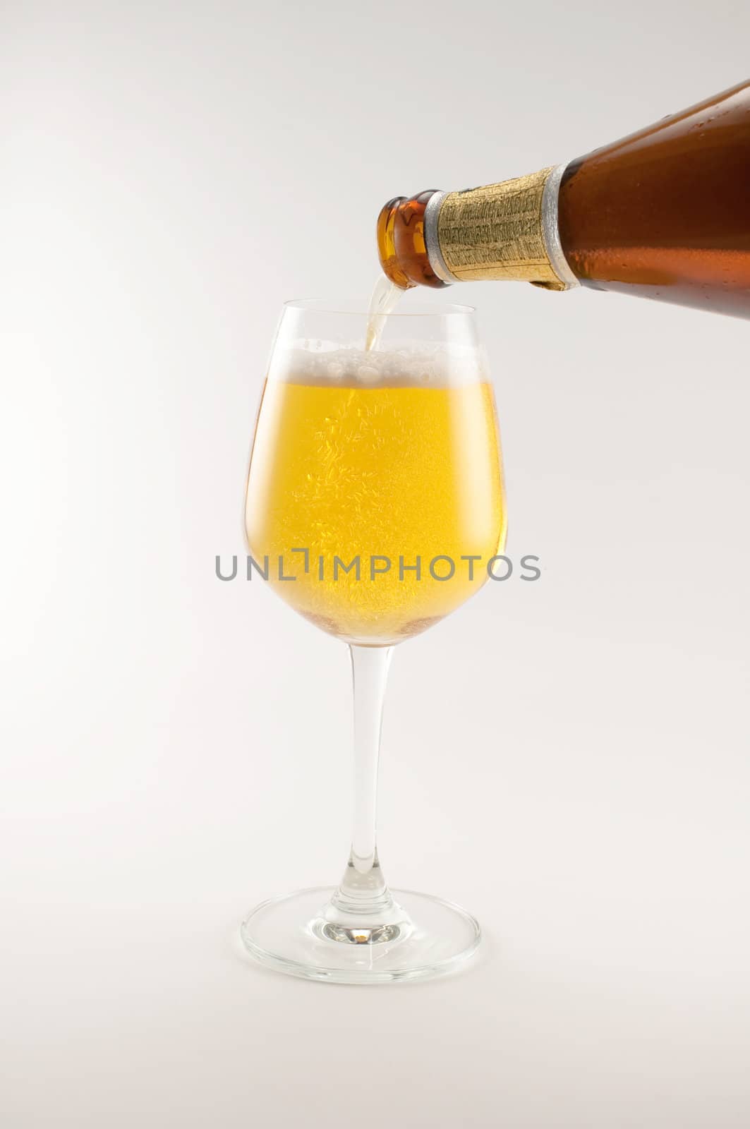 bottle and glass of beer on white background