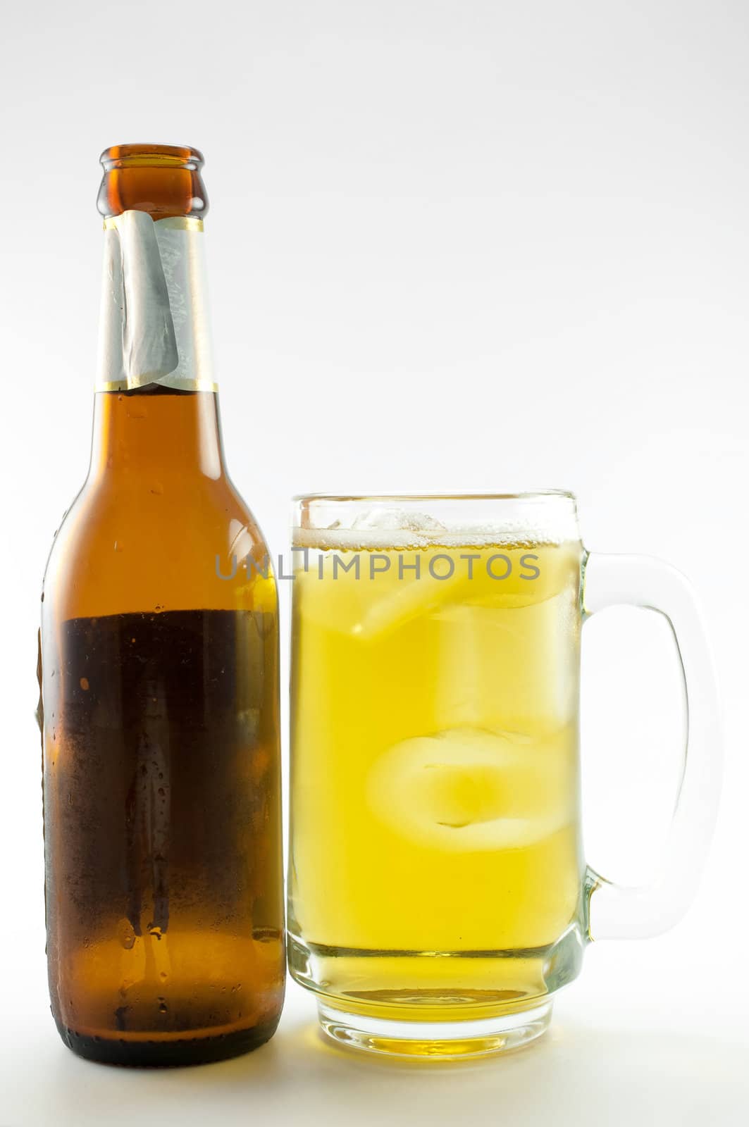 bottle and glass of beer on white background