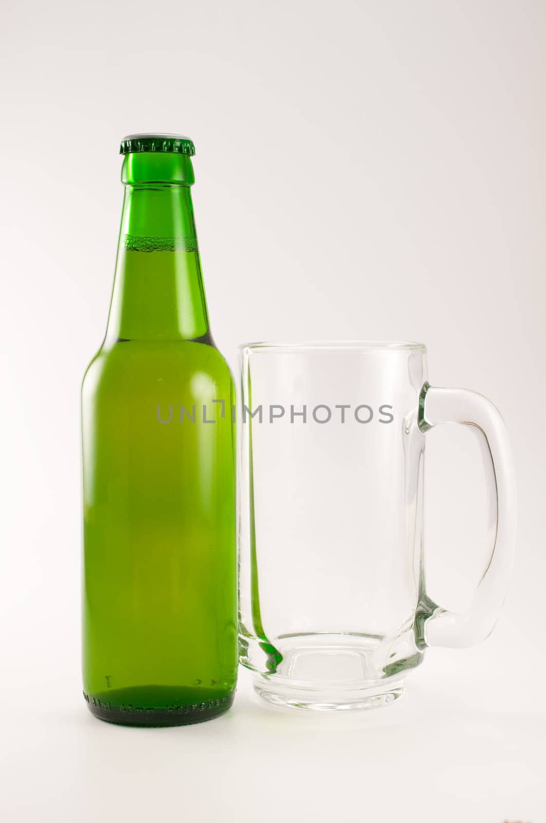 bottle and glass of beer on white background