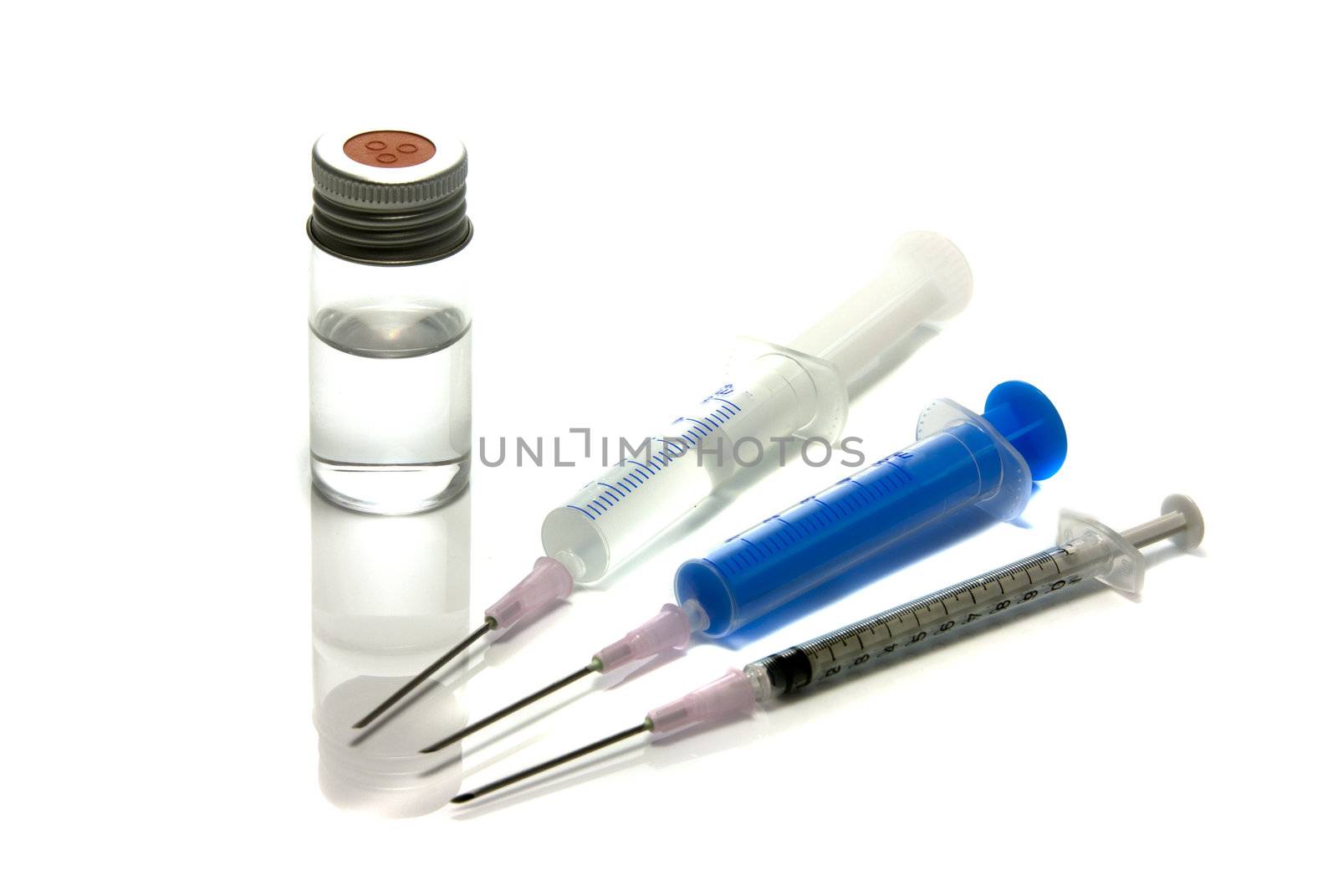 medical needle in bottle with liquid by compuinfoto