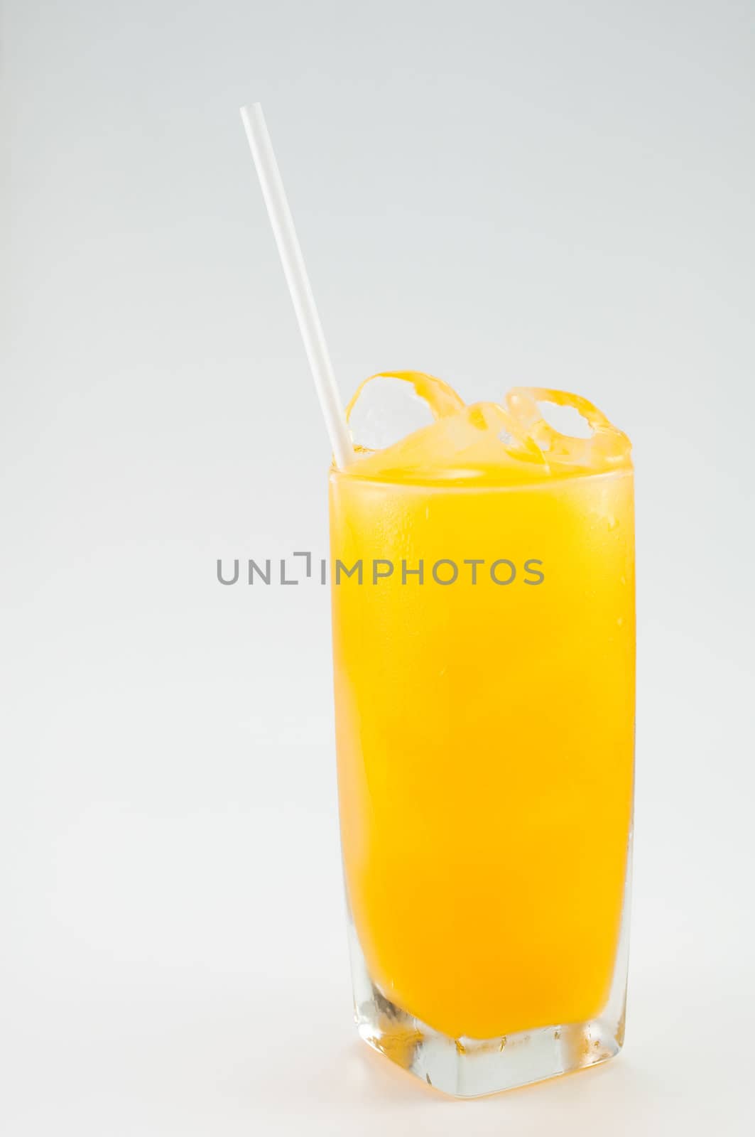 a glass of orange juice on white background