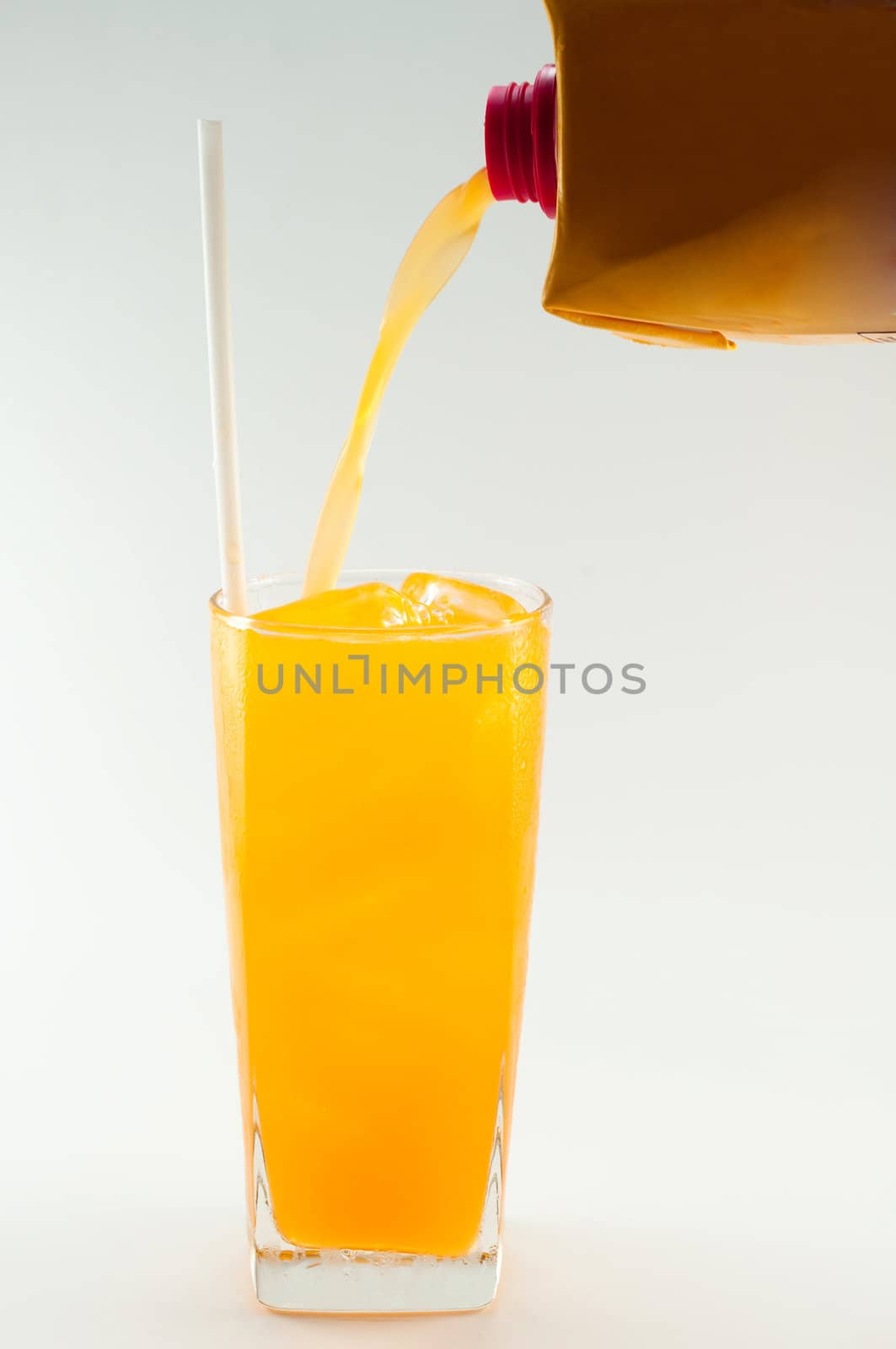 a glass of orange juice on white background