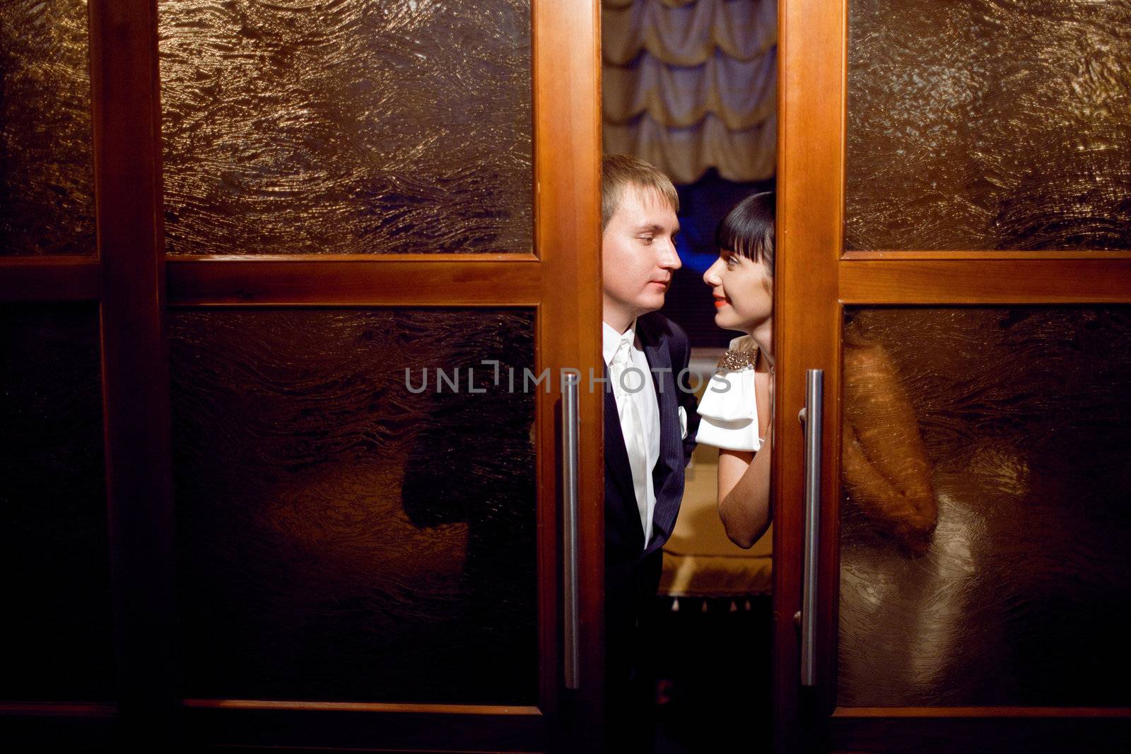 bride and groom near the door