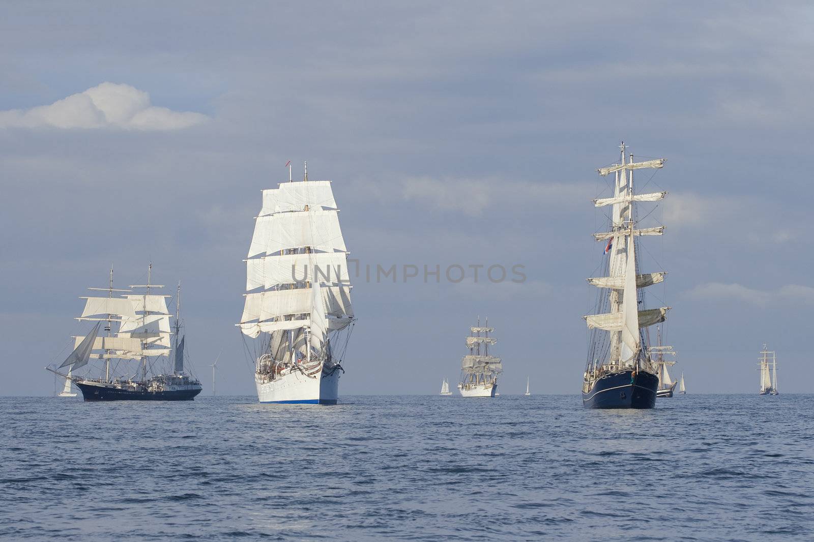 Several tall ships in a row before start a regatta