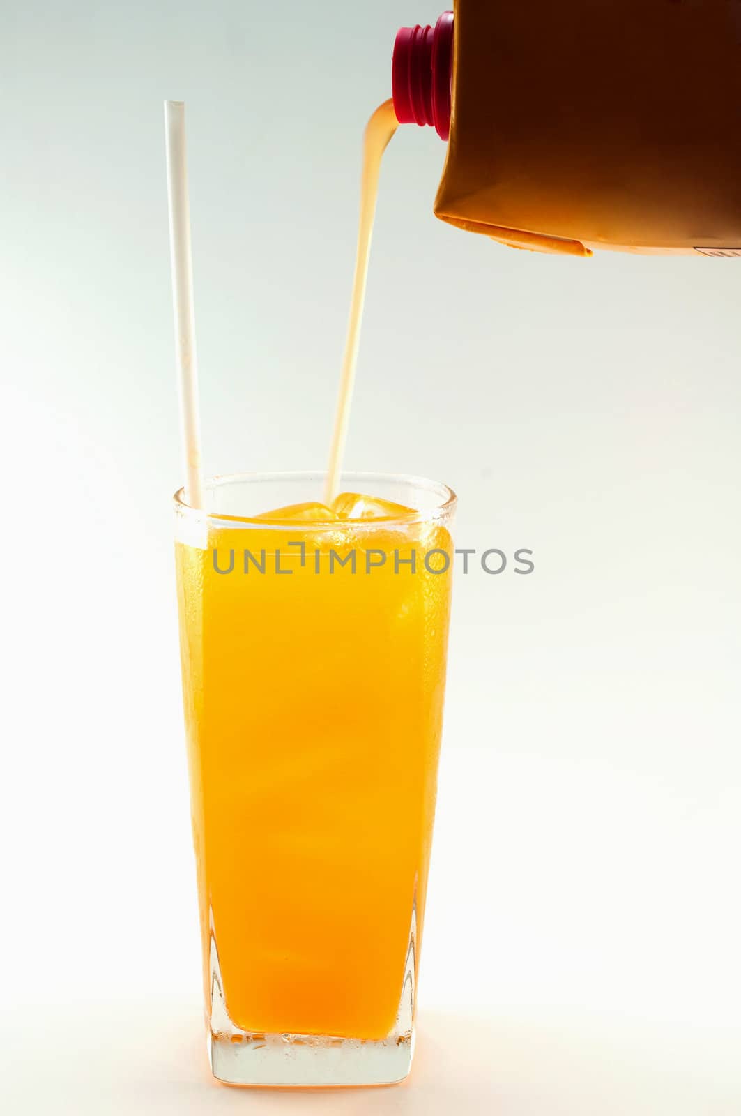 a glass of orange juice on white background