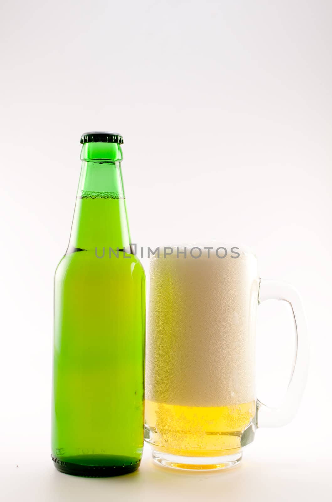 bottle and glass of beer on white background
