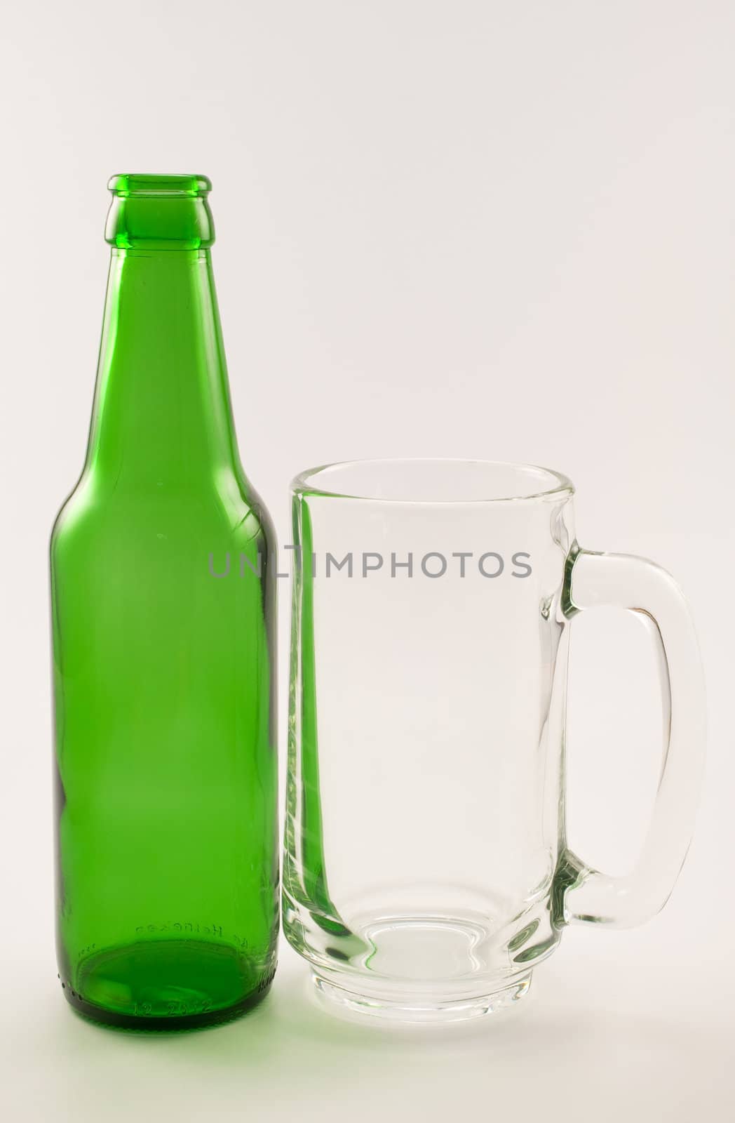 bottle and glass of beer on white background