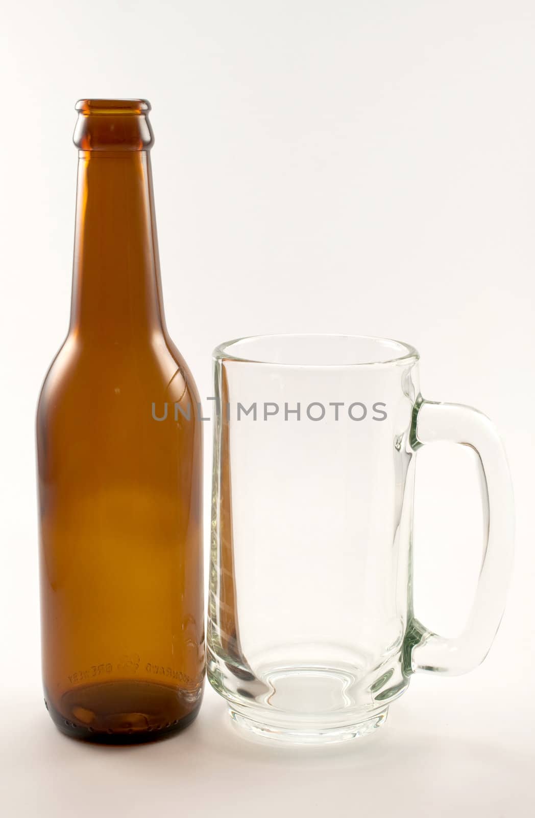 bottle and glass of beer on white background