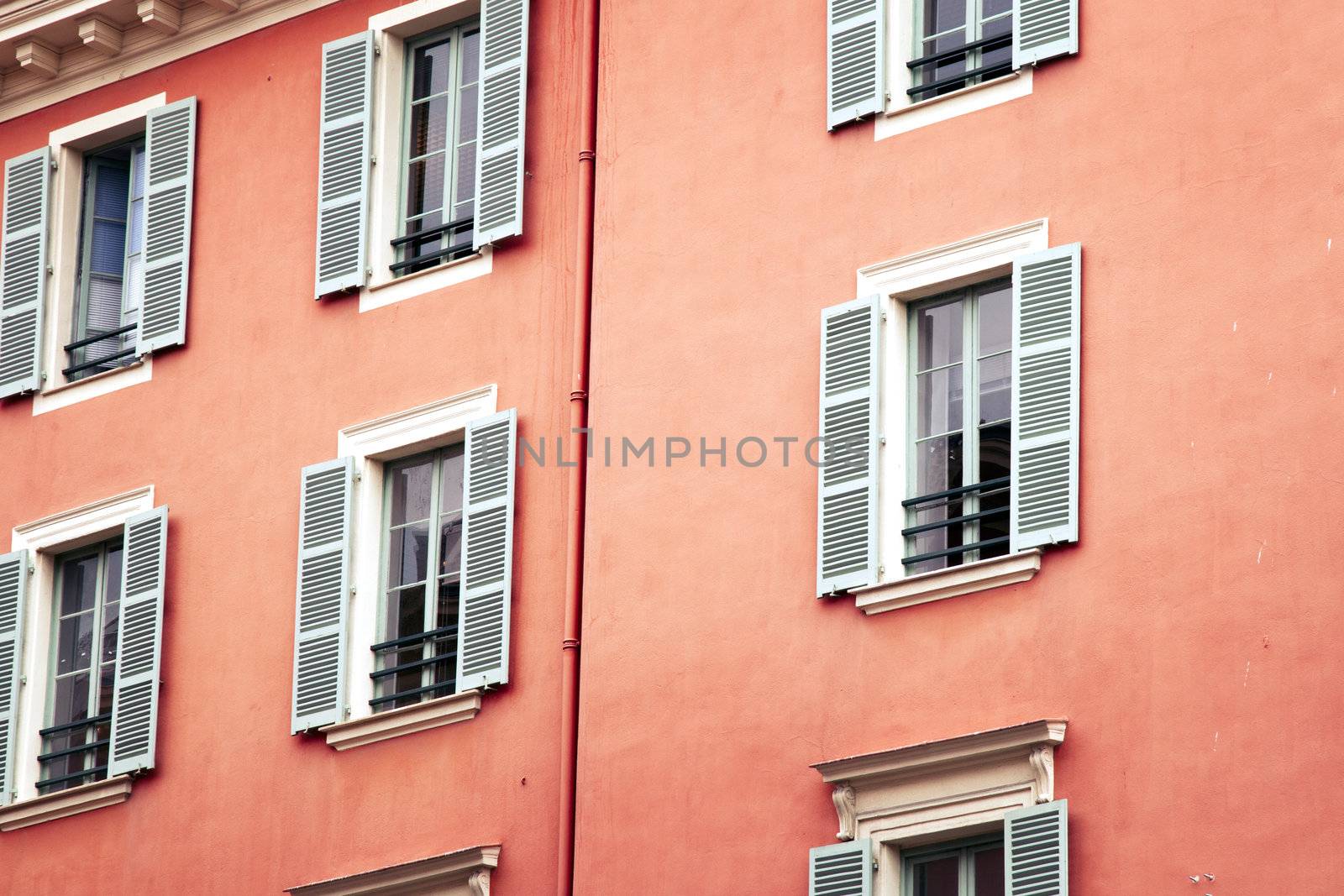 Shuttered windows on building in Nice France.