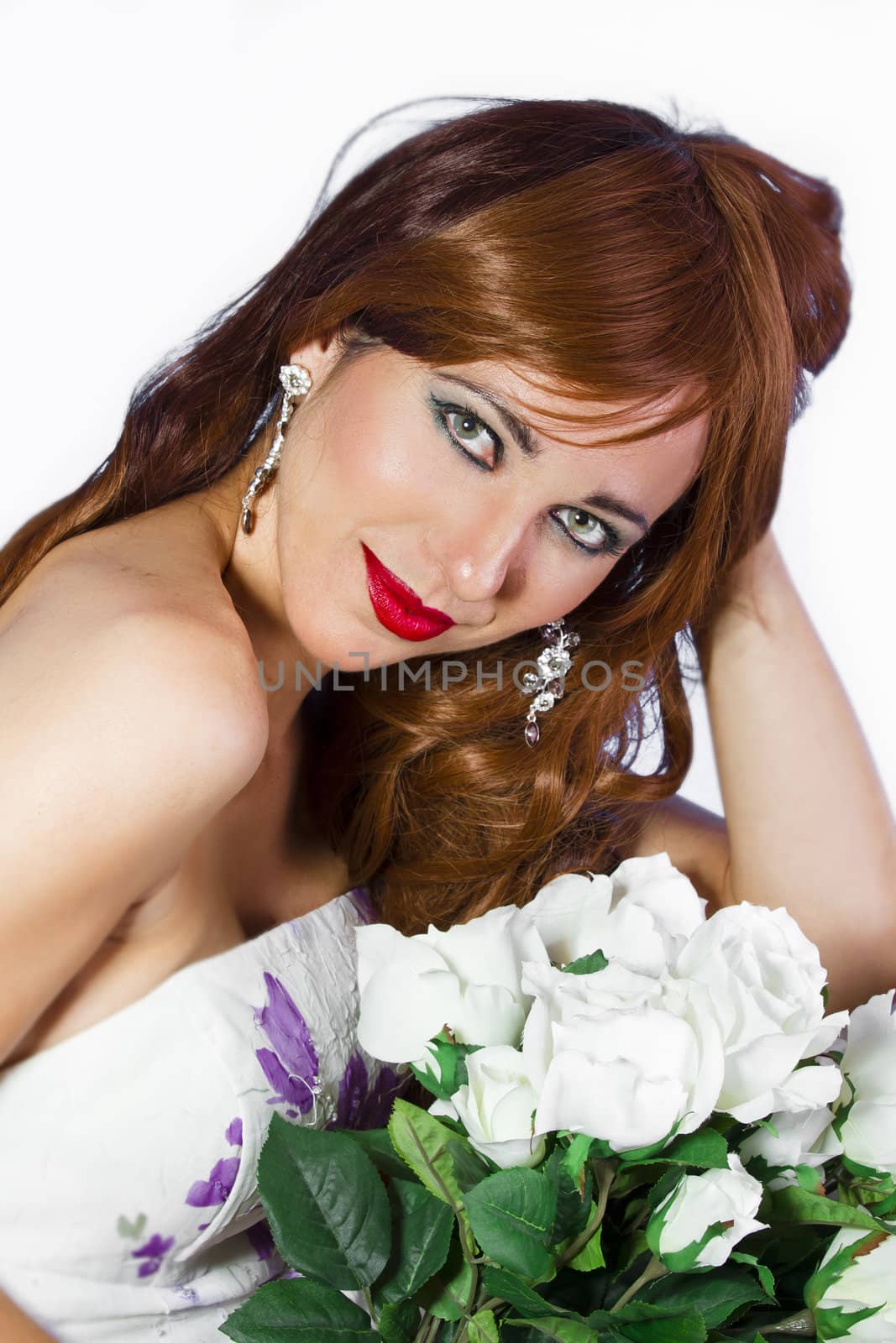 Beautiful red-haired woman with a bouquet of white roses on a white background