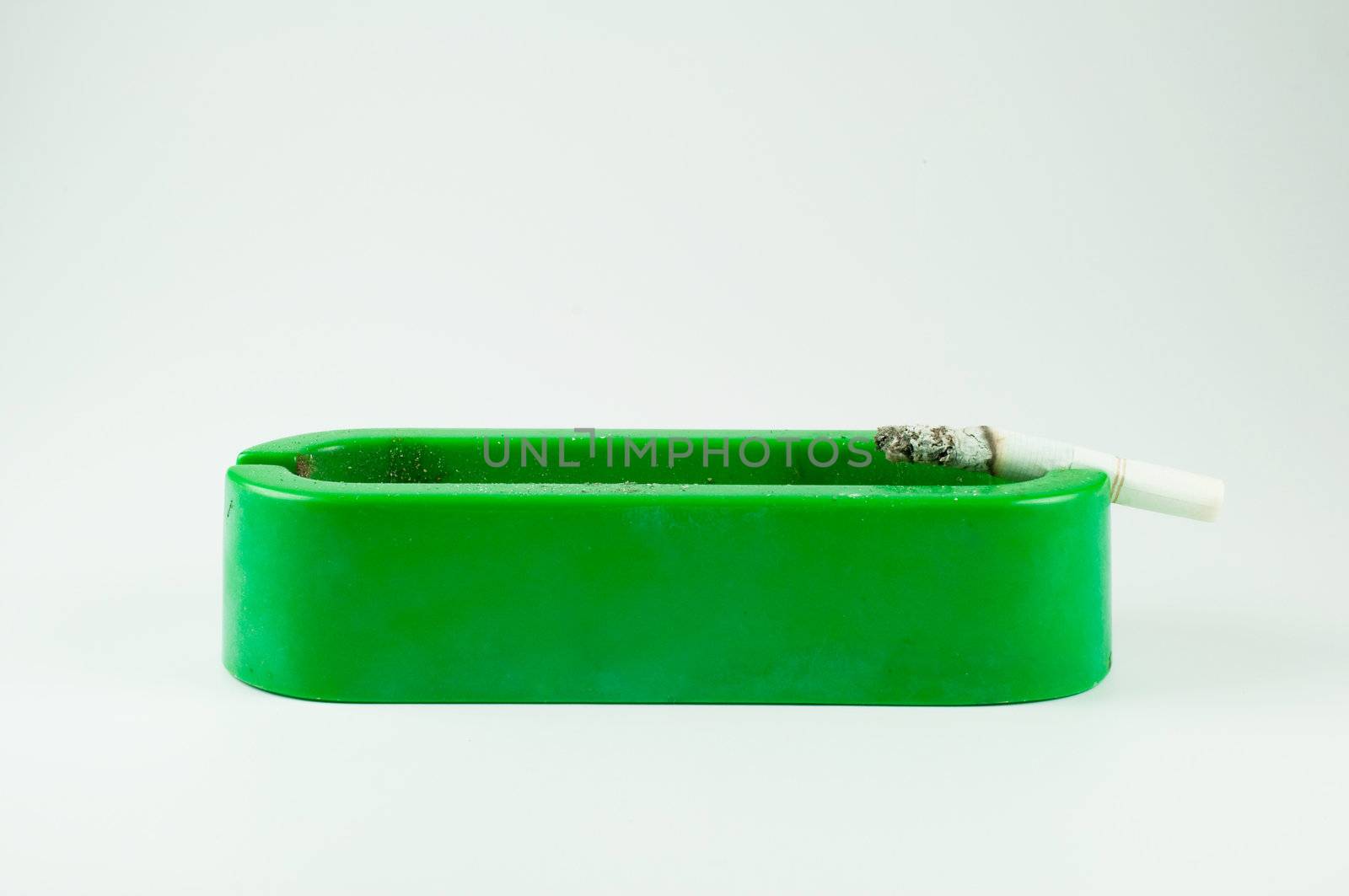 green ashtray on white background