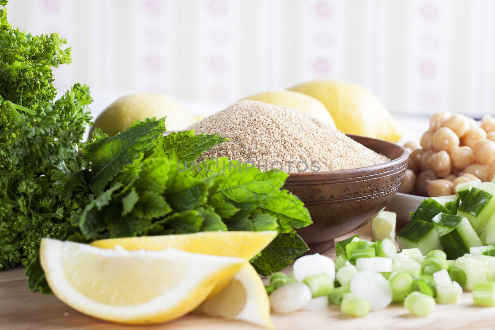Ingredients for meal including lemon, cucumber, amaranth grains, chickpeas and fresh mint.