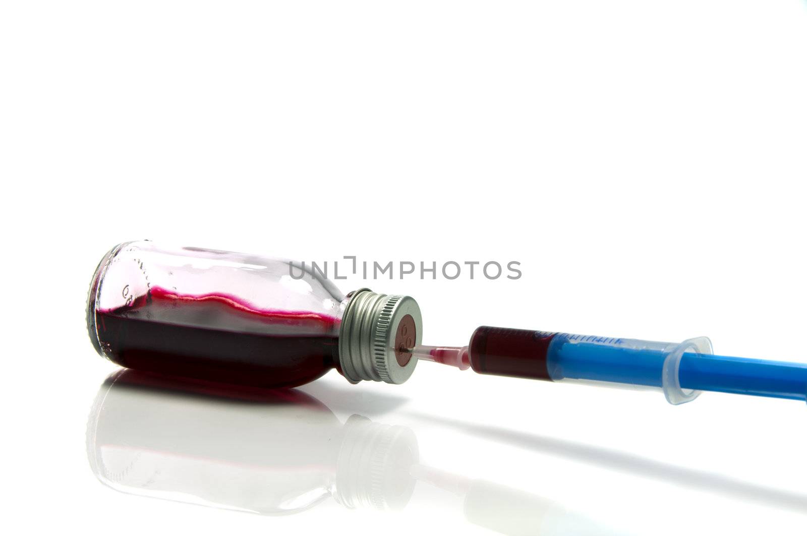 medical needle in bottle with blood by compuinfoto