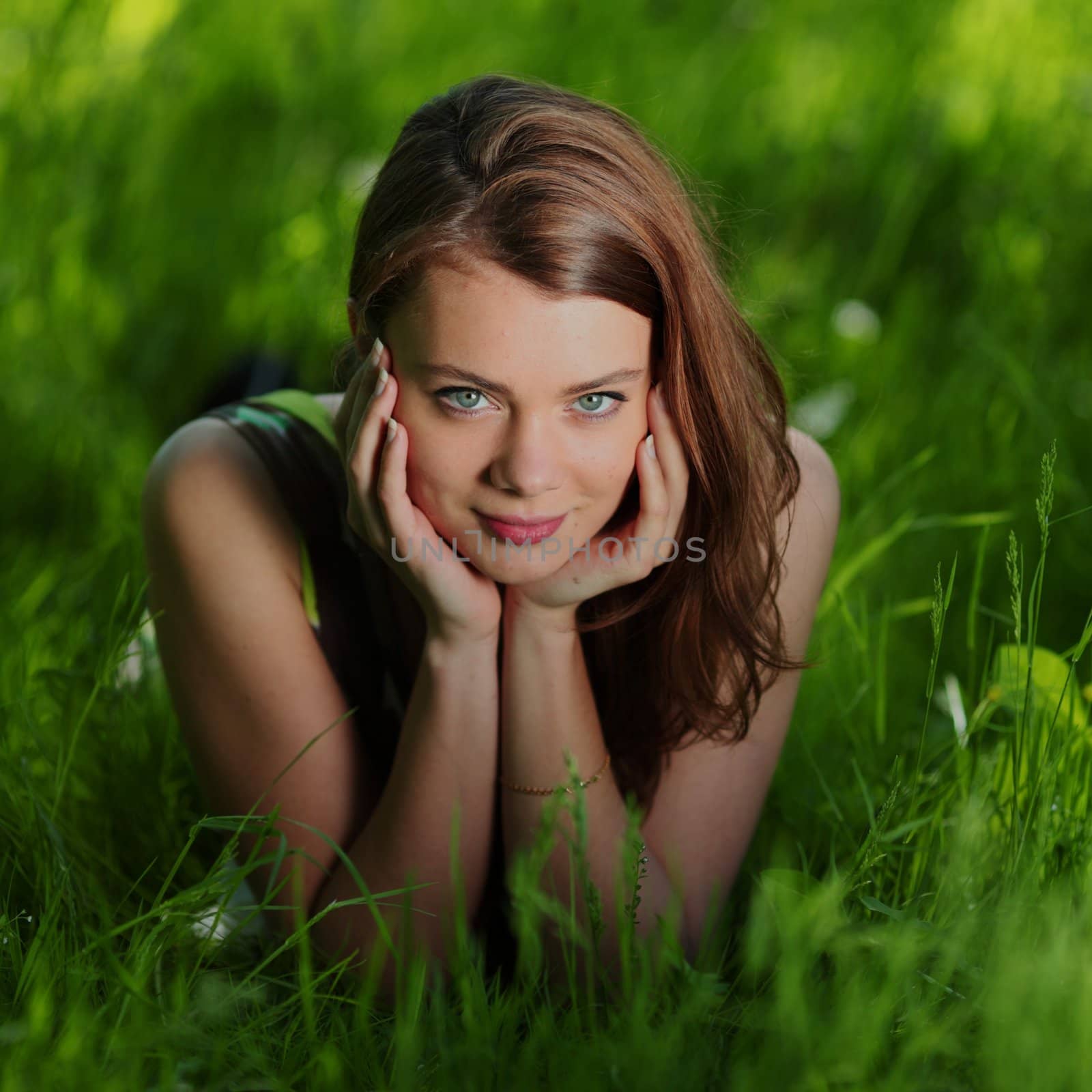 beautiful woman laying on grass