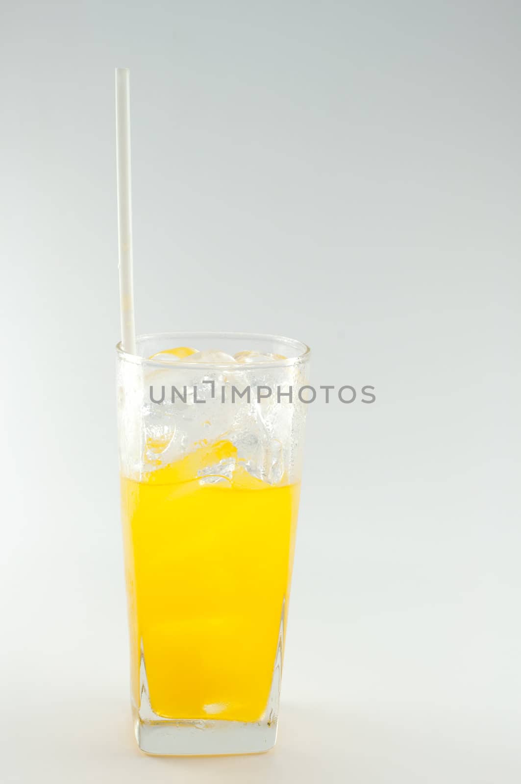 a glass of orange juice on white background