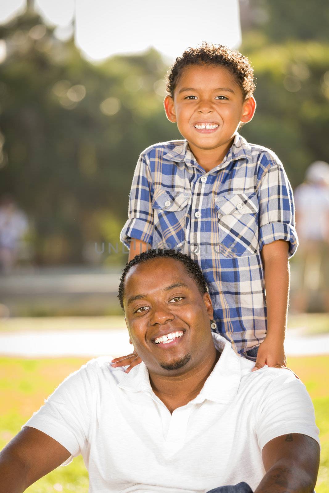 Happy African American Father and Mixed Race Son Playing in the Park.