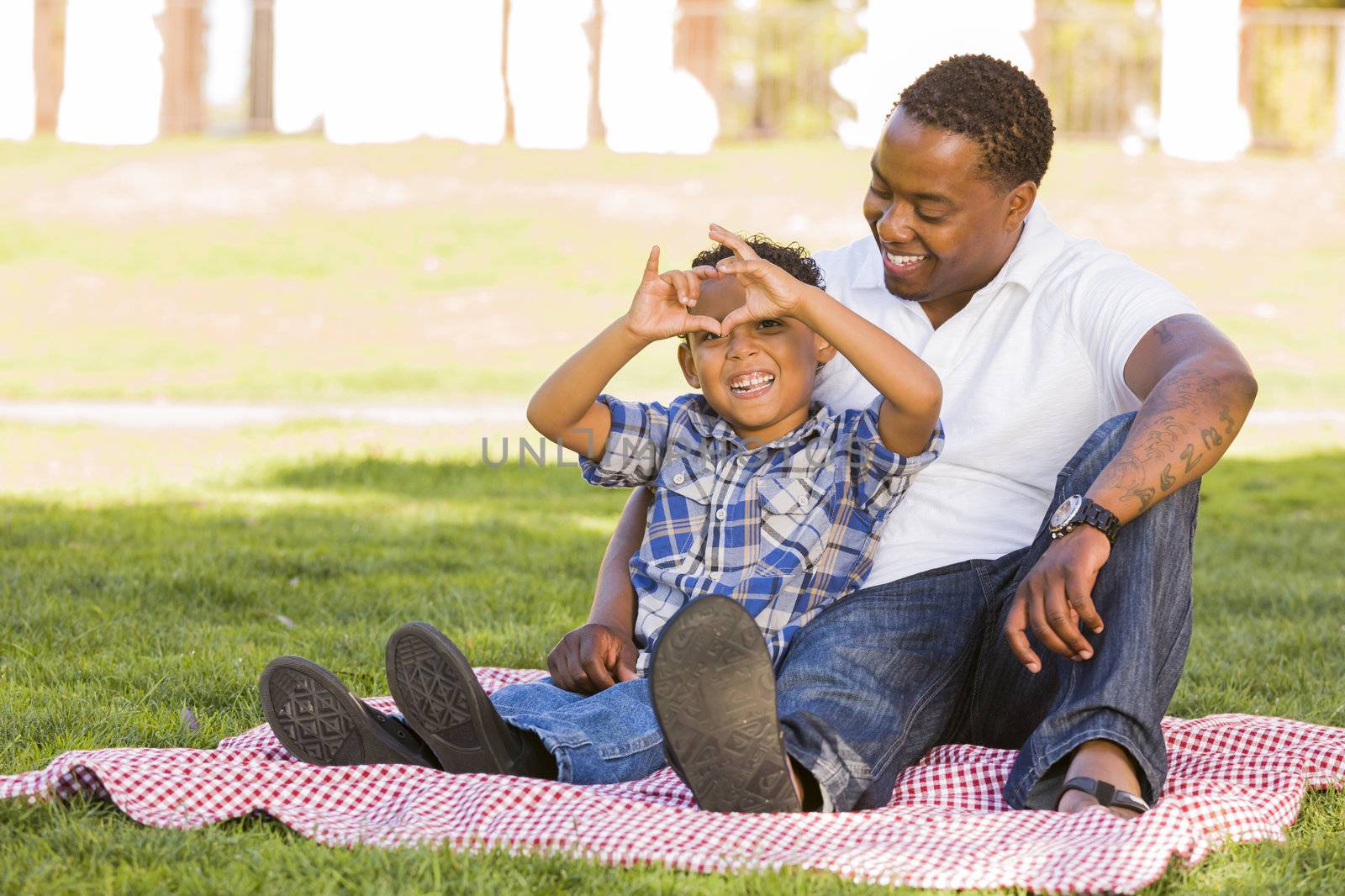 Mixed Race Father and Son Making Heart Hand Sign by Feverpitched