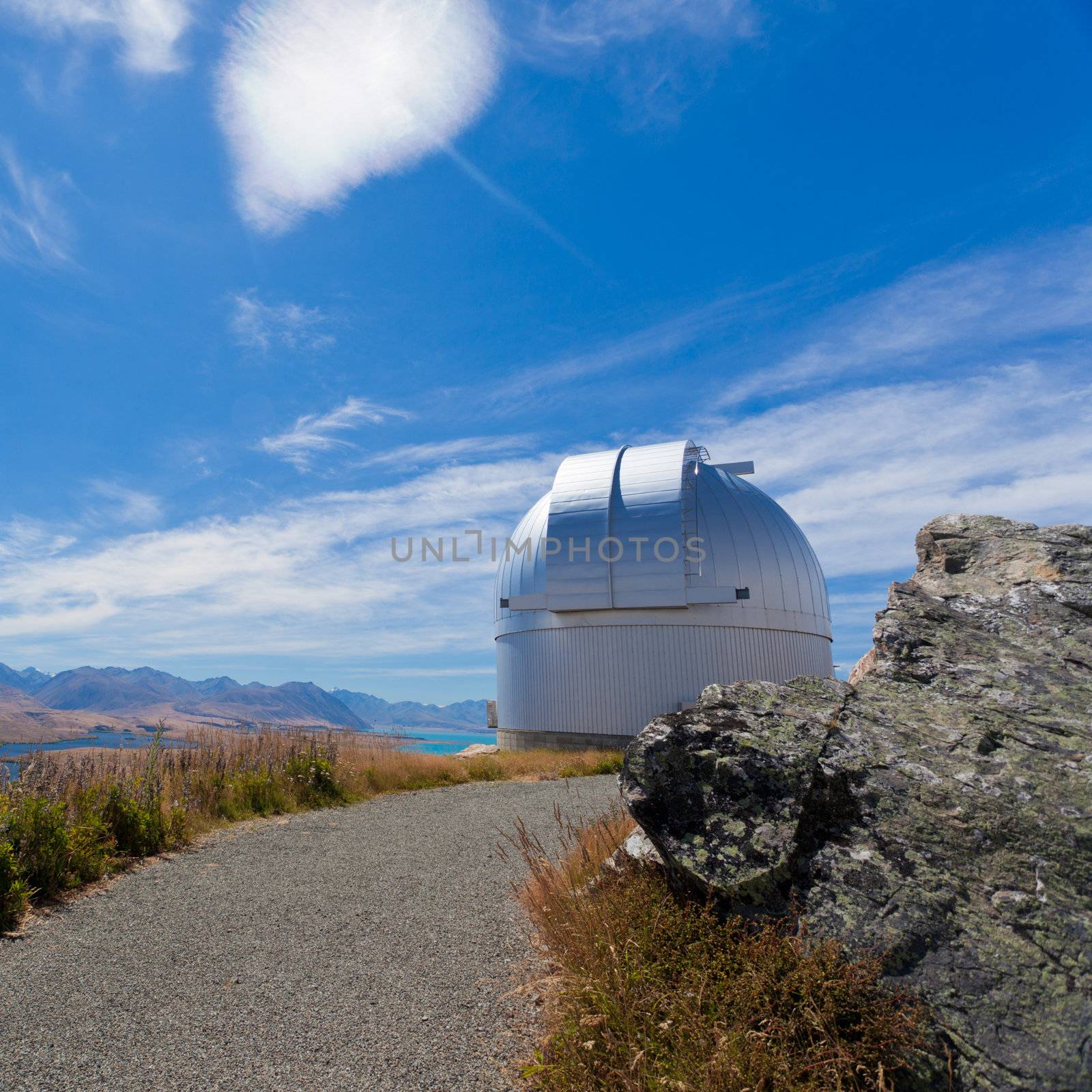 Domed astronomy observatory building housing a telescope for astronomical and meteorological observations standing on a mountain top to afford a clear view
