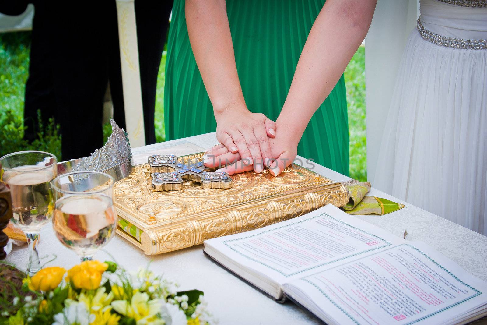 Hands on bible at a wedding ceremony
