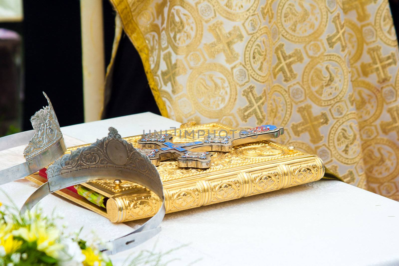 Wedding crowns and cross on a bible prepared for ceremony