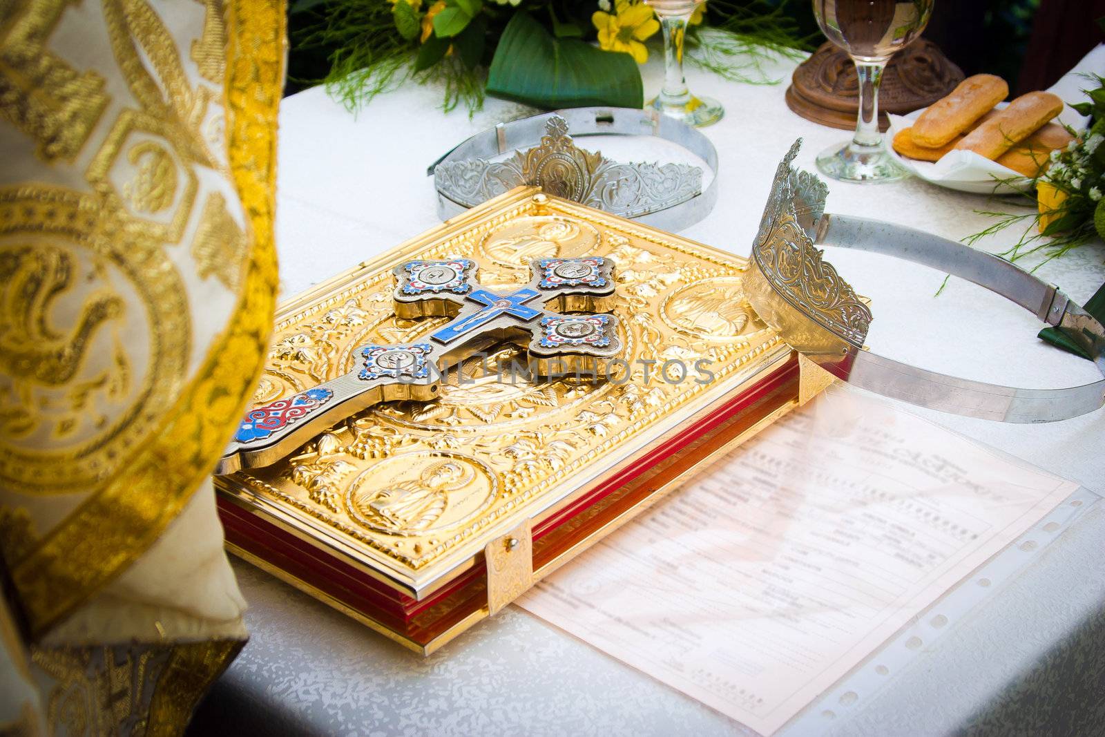 Wedding crowns and cross on a bible prepared for ceremony
