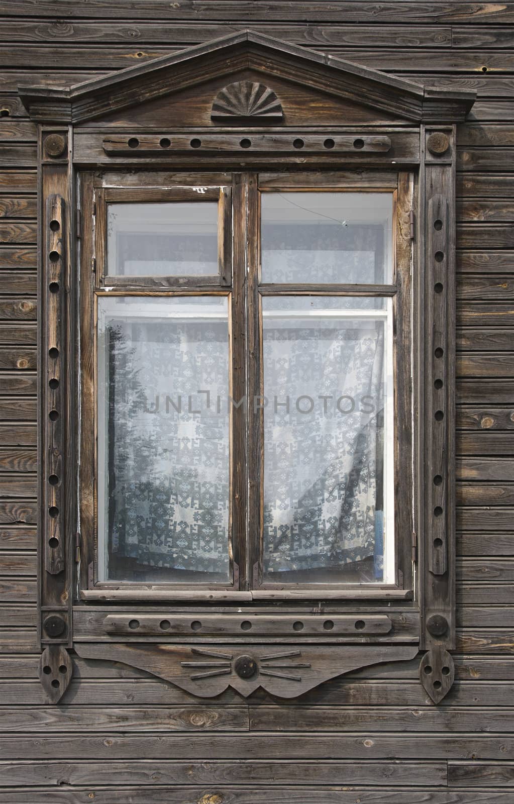 Window of an old russian house decorated with carving