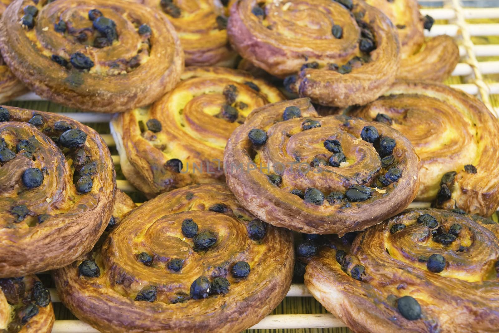 Fresh danish pastry with raisins on a tray