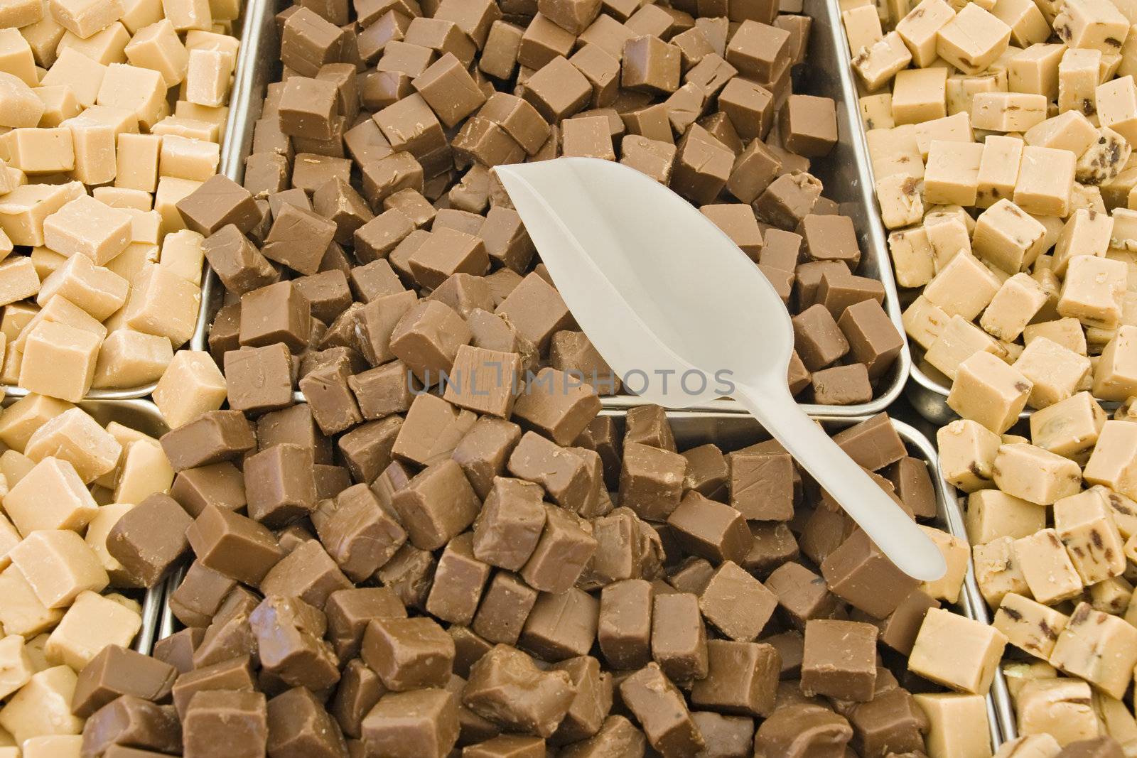 Brown and yellow toffee cubes in a market