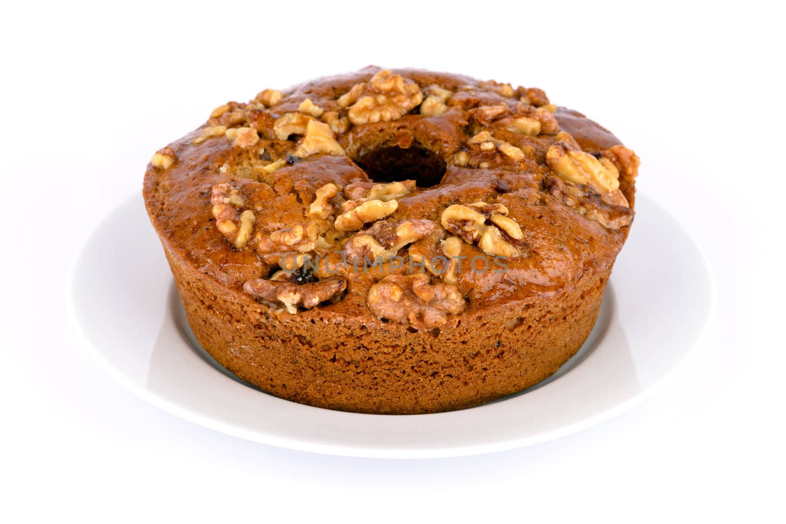 Homemade fresh honey cake with nuts on dish.