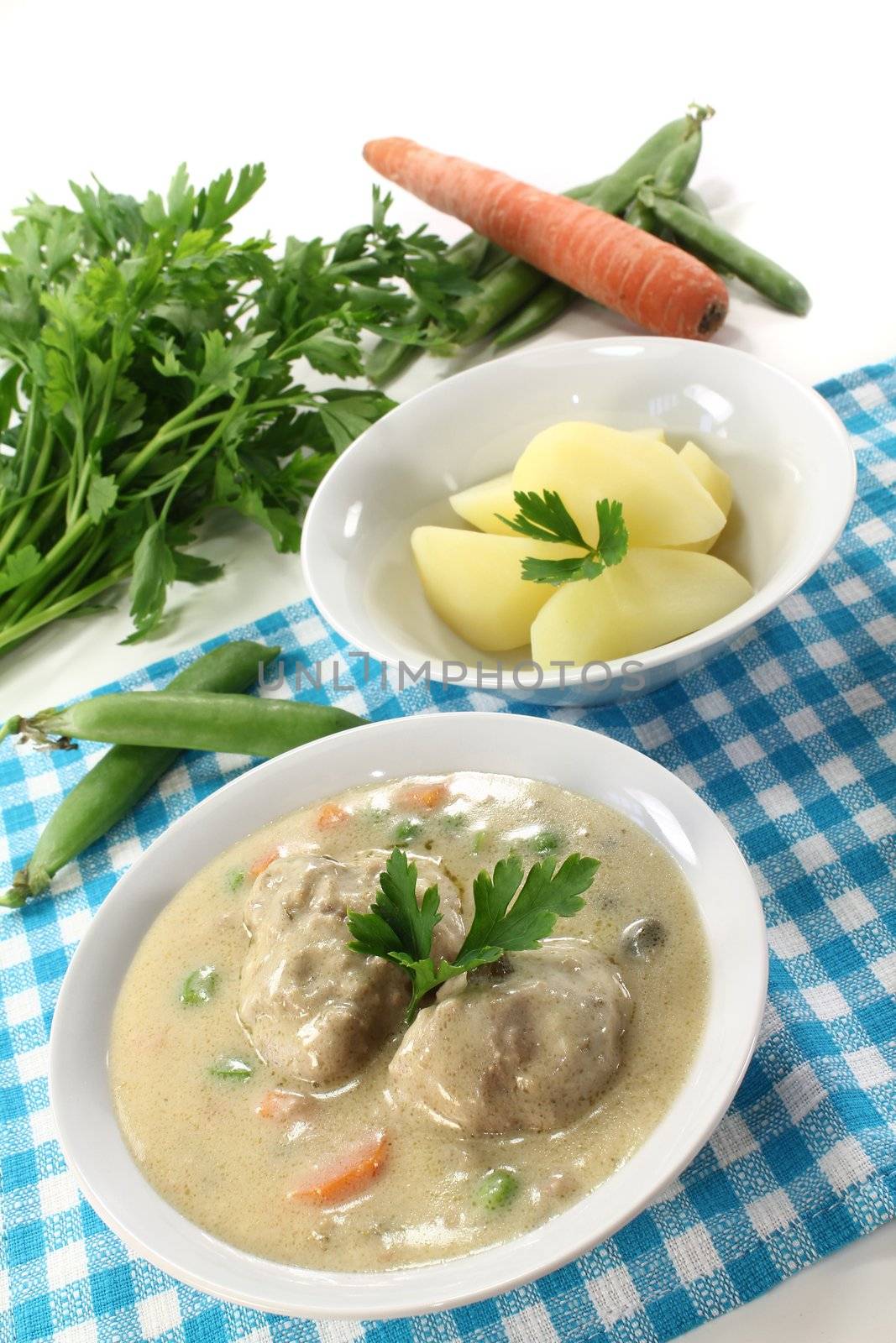 cooked meatballs with capers, peas and carrots