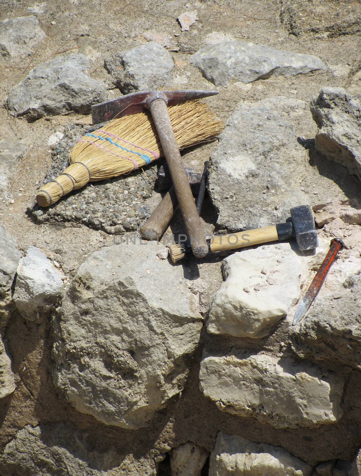 Set of archaeologist digging tools on ancient excavation site