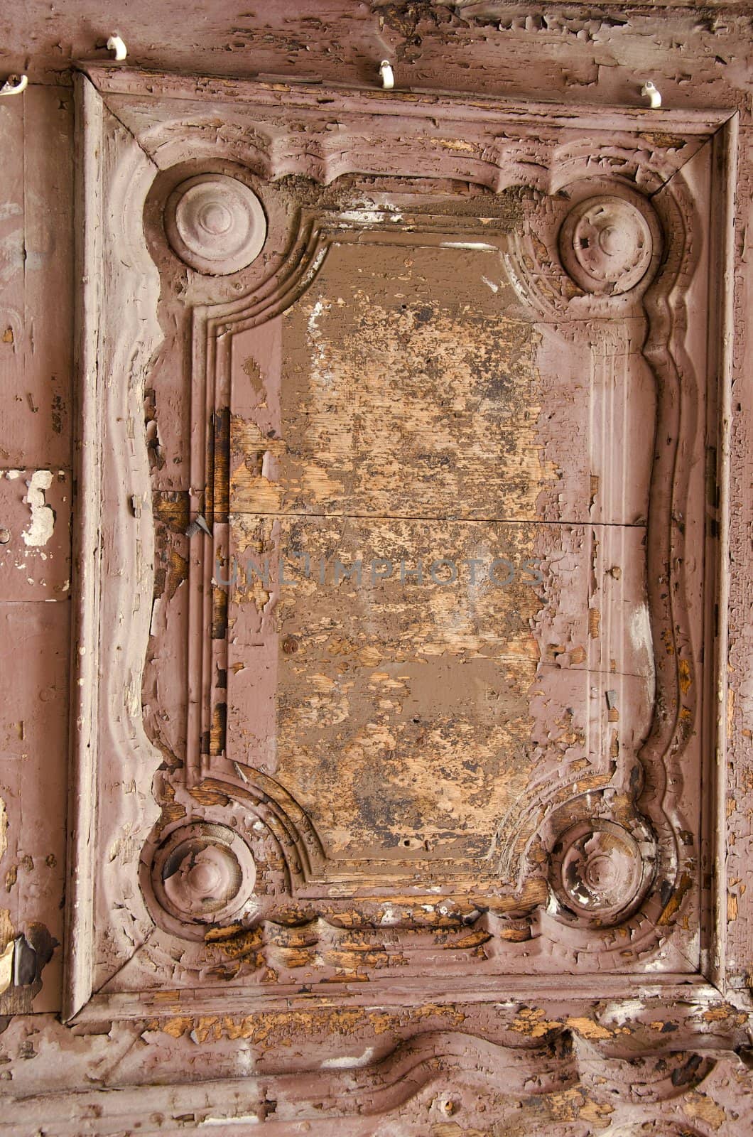 Old wooden door fragment. Architectural ornaments and peeled paint.