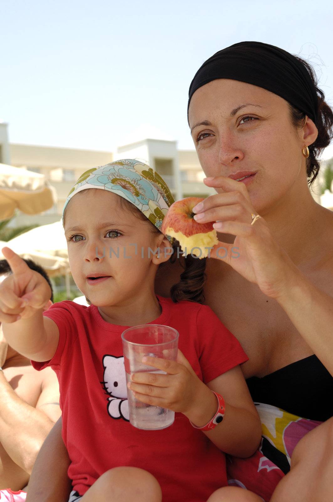 Healthy family. Mother and child eating apple and drinking water