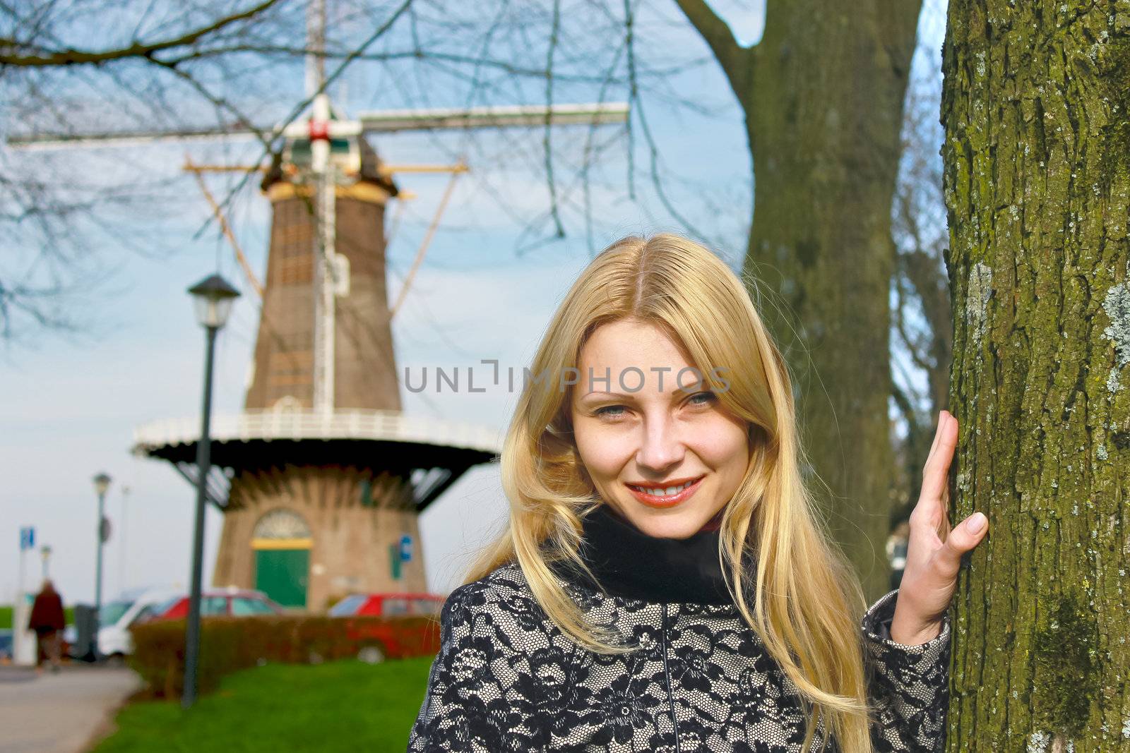 Girl near  windmill in  Dutch town of Gorinchem. Netherlands by NickNick