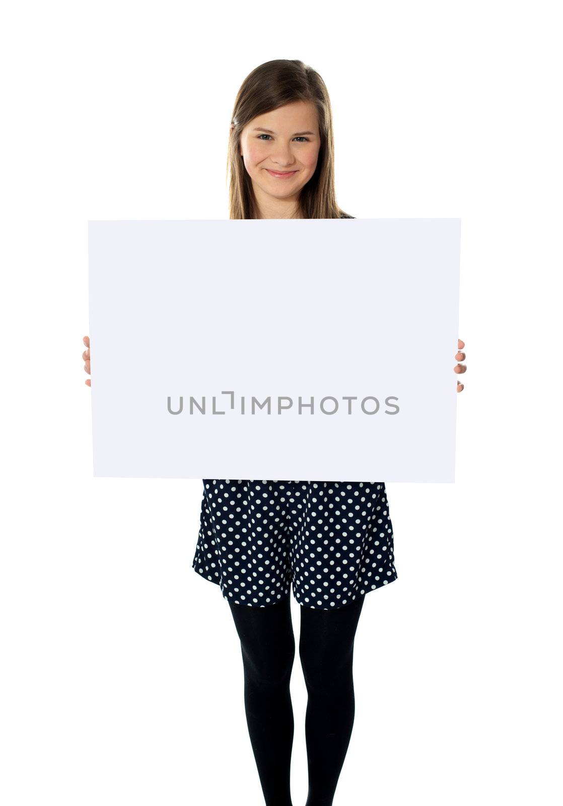 Smiling cute isolated girl displaying blank white poster
