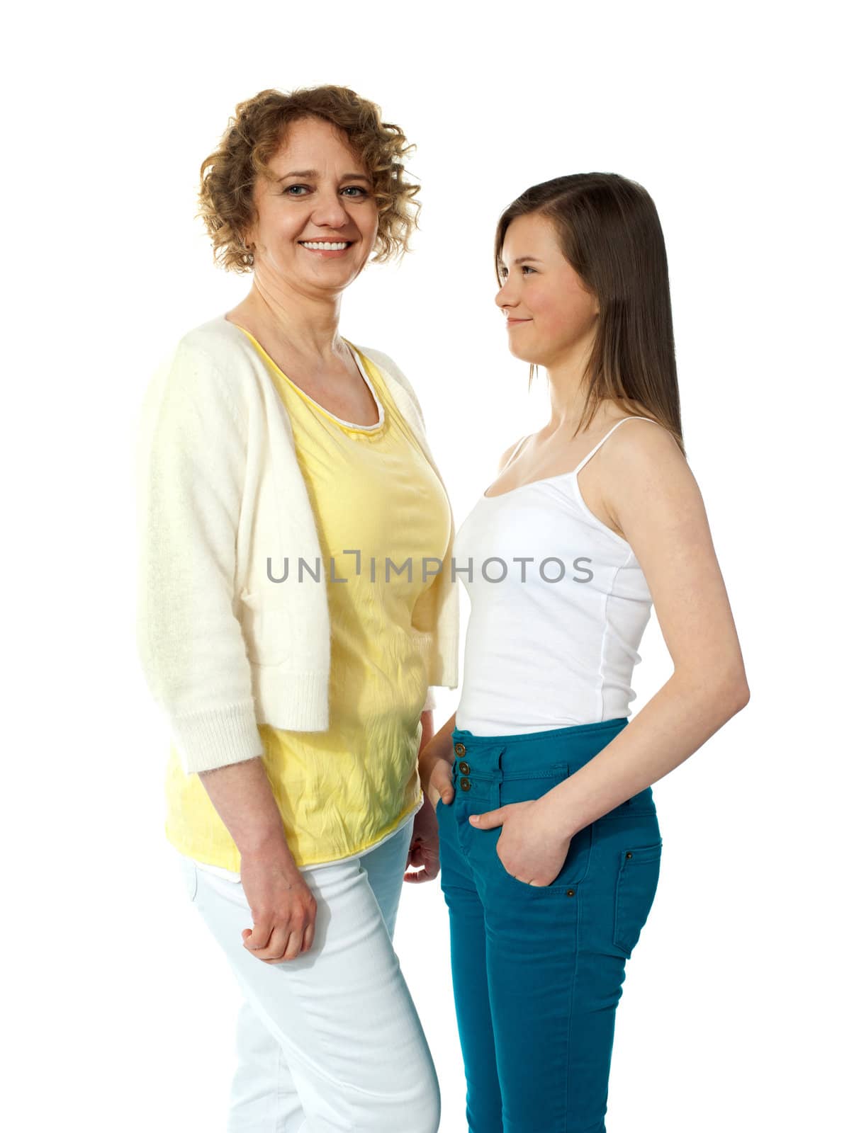 Pretty teenage girl looking at her modern mum. All on white background