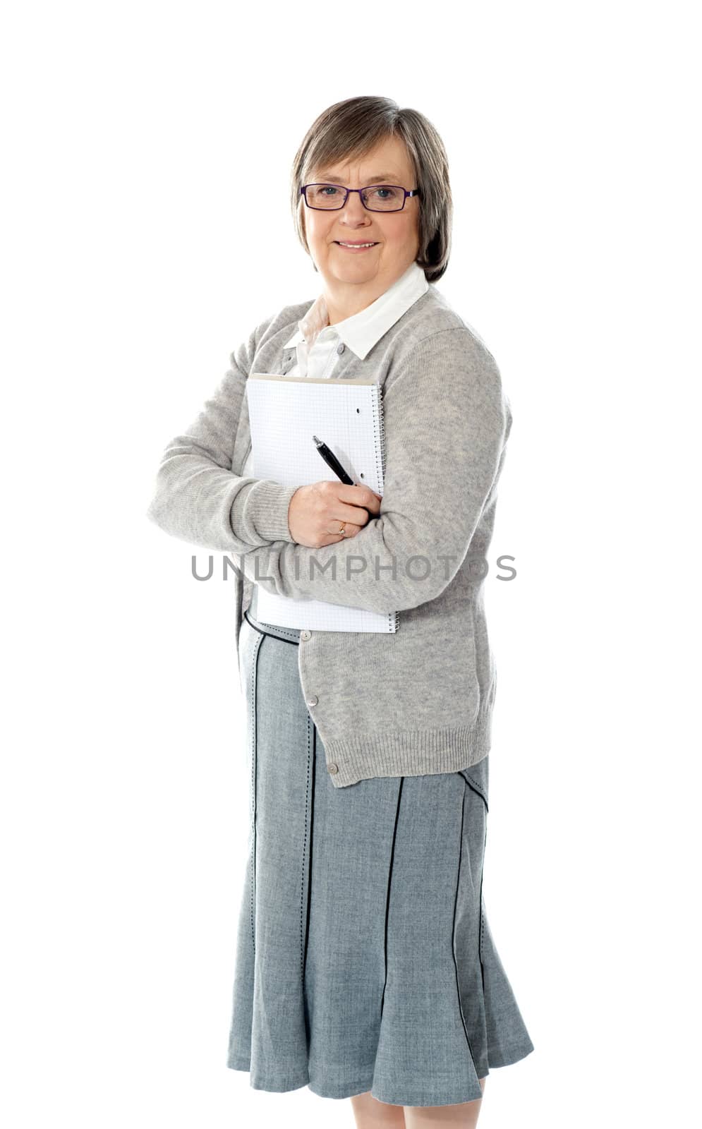 Senior woman holding spiral notepad and pen. Smiling at camera