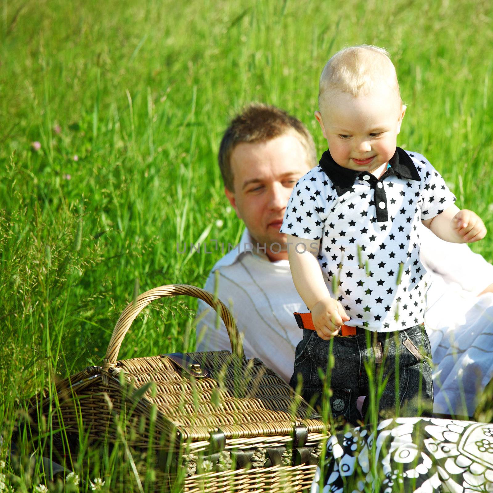 father and son in the grass