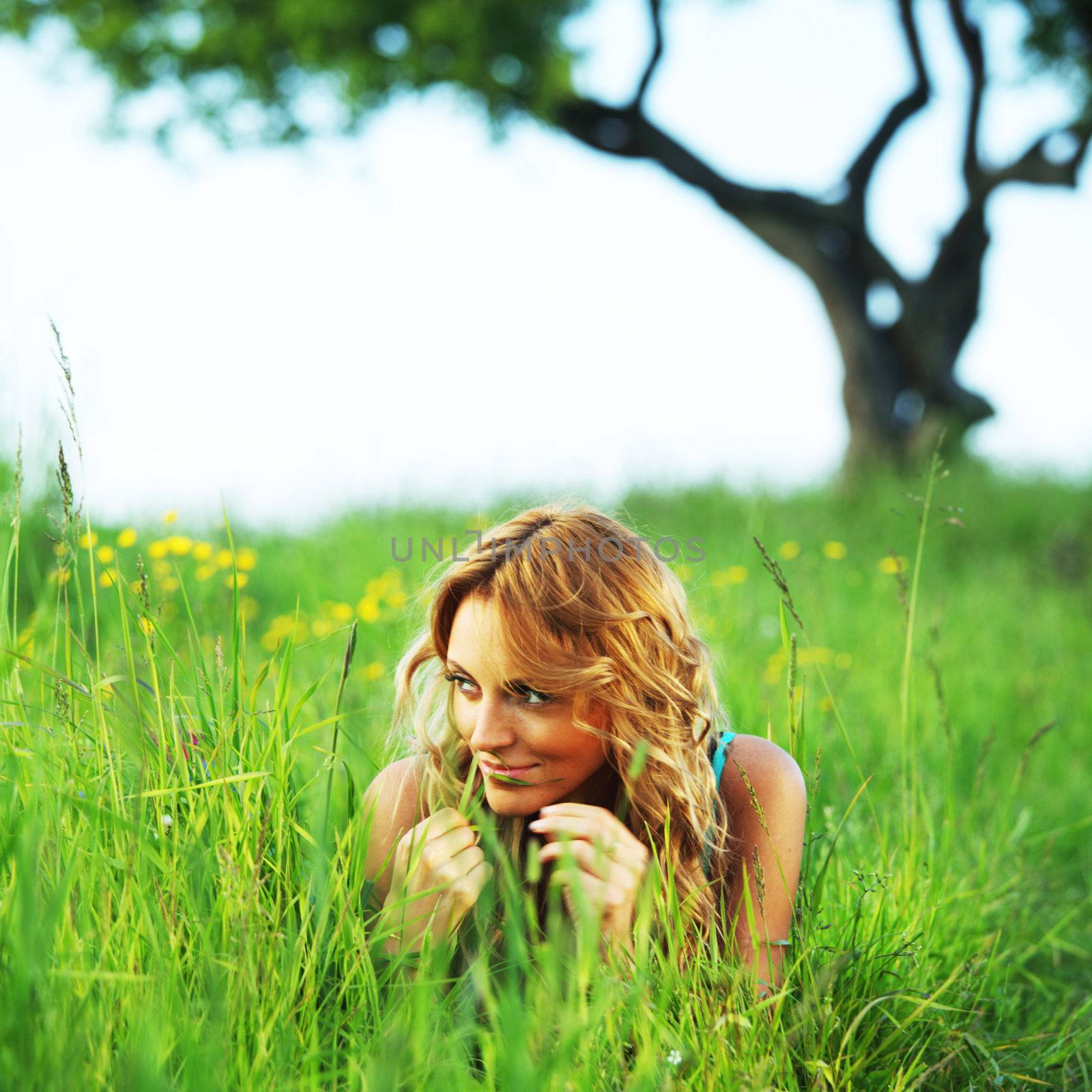  woman on the green grass under tree happy and smile
