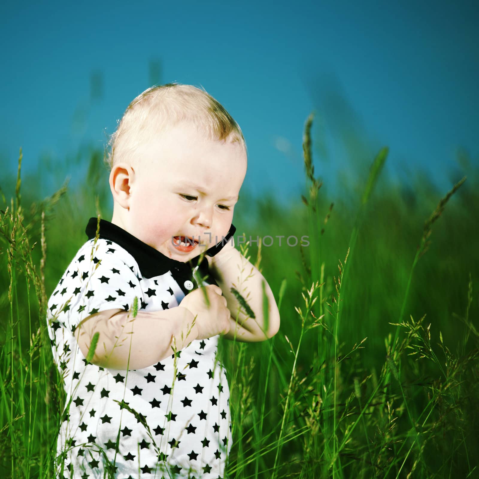 boy in grass call by phone by Yellowj