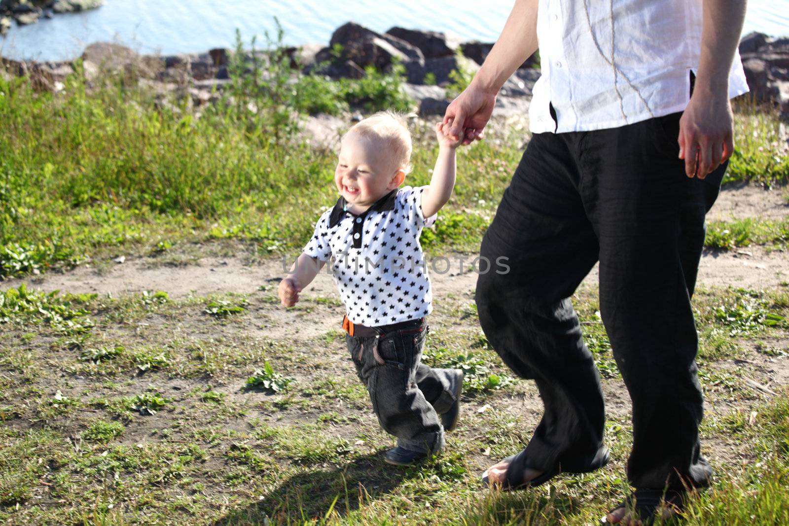 father and son walking on grass