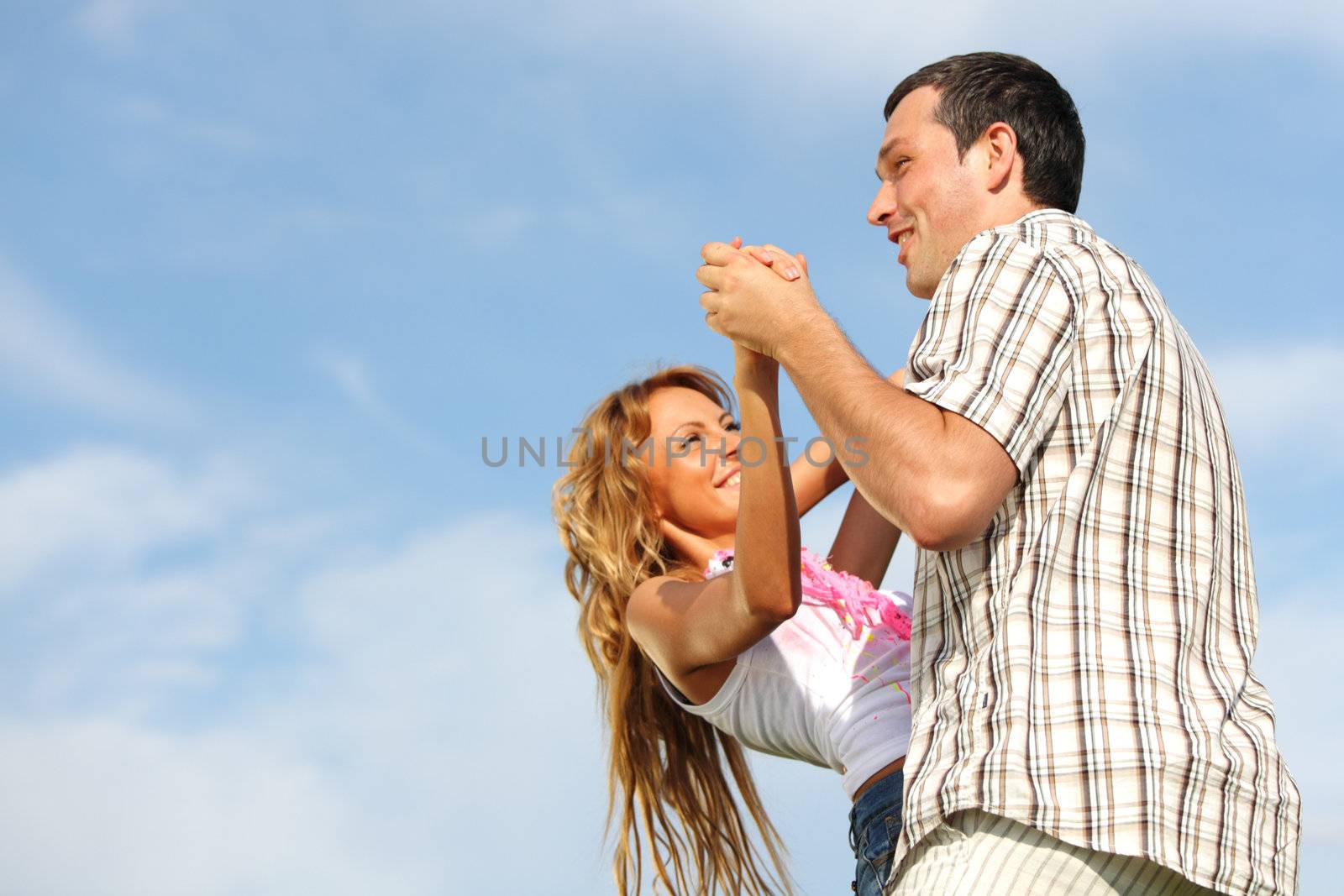 man and woman dance in the sky