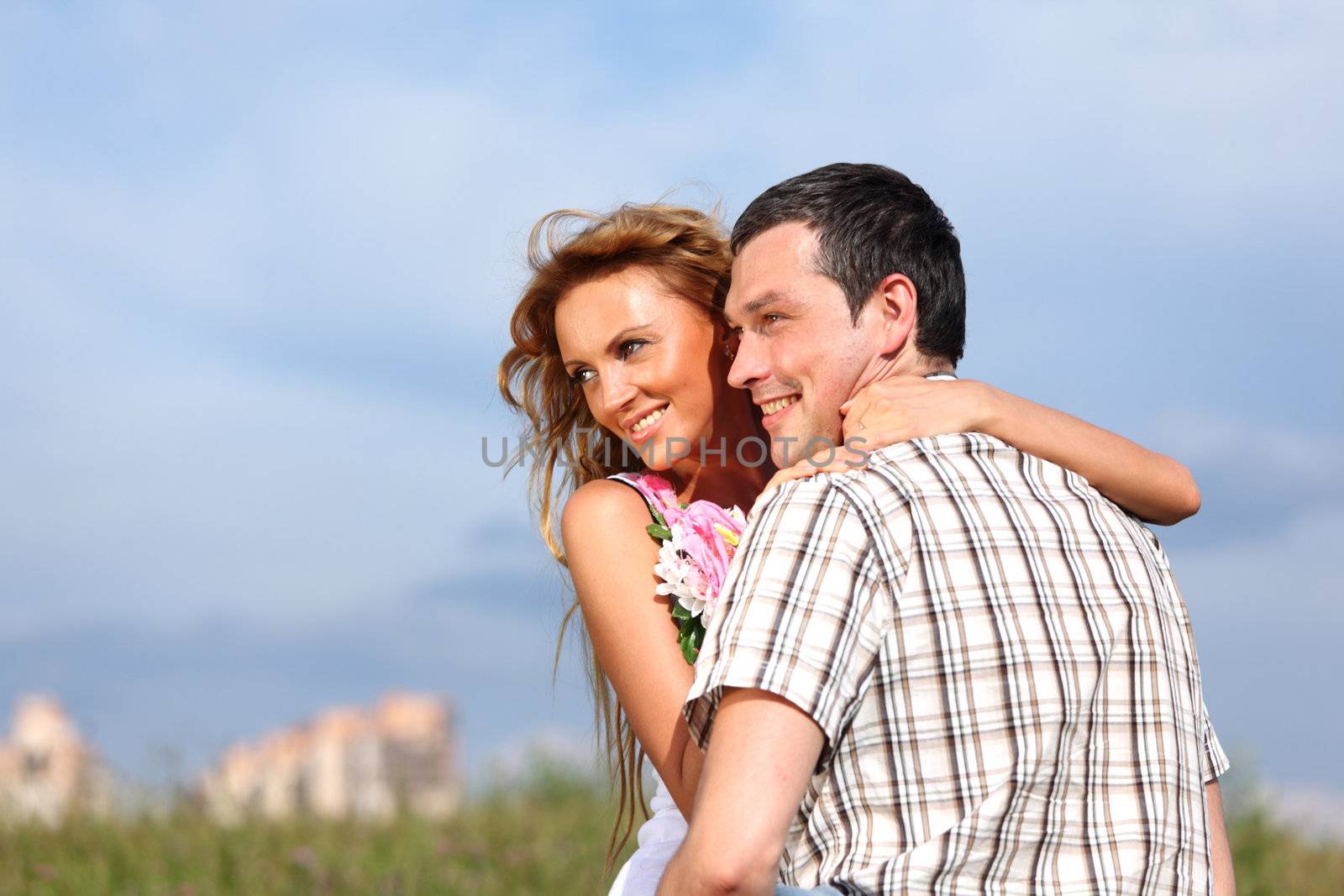 man and woman hug in the sky
