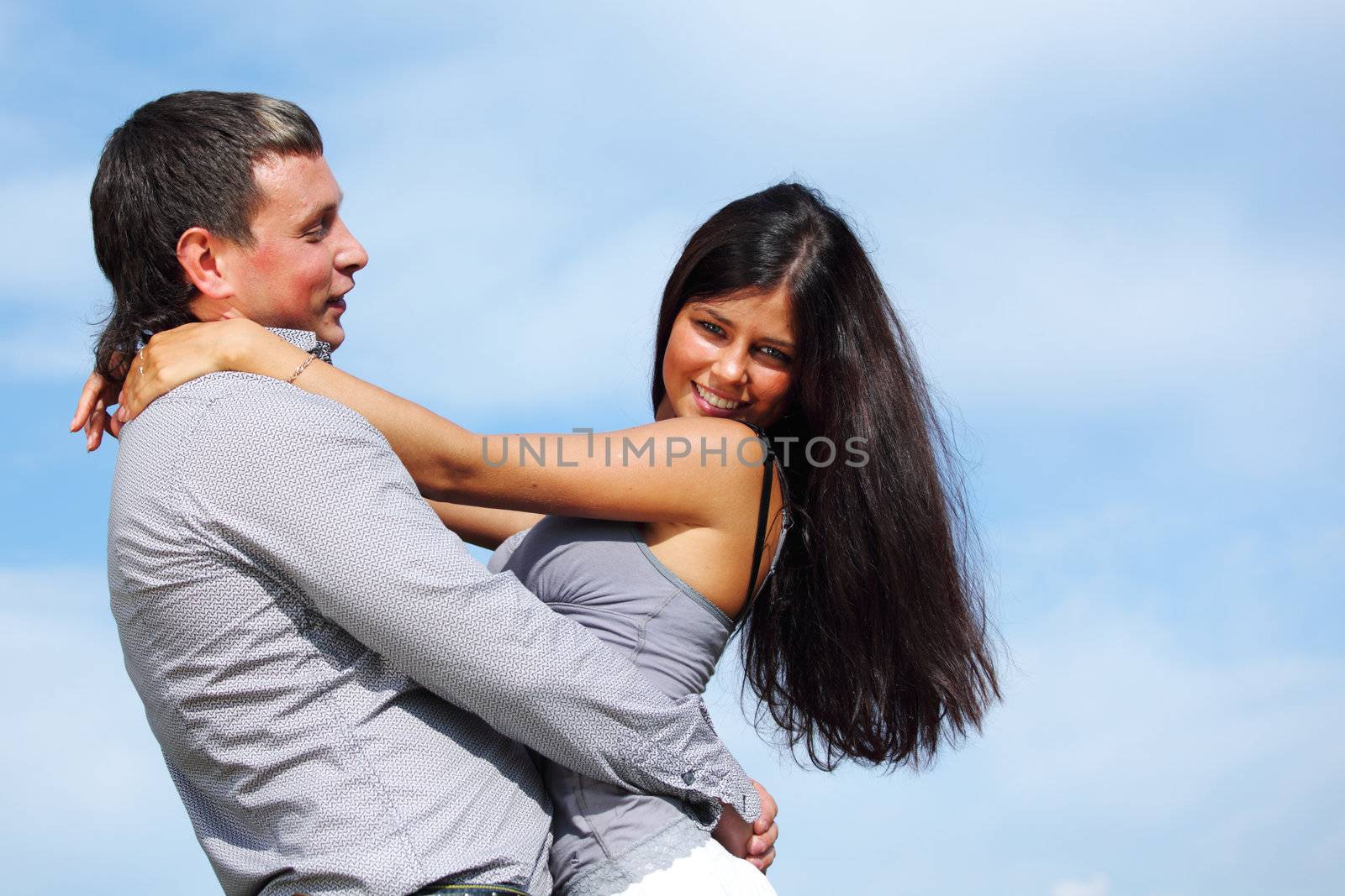 man and woman hug in the sky