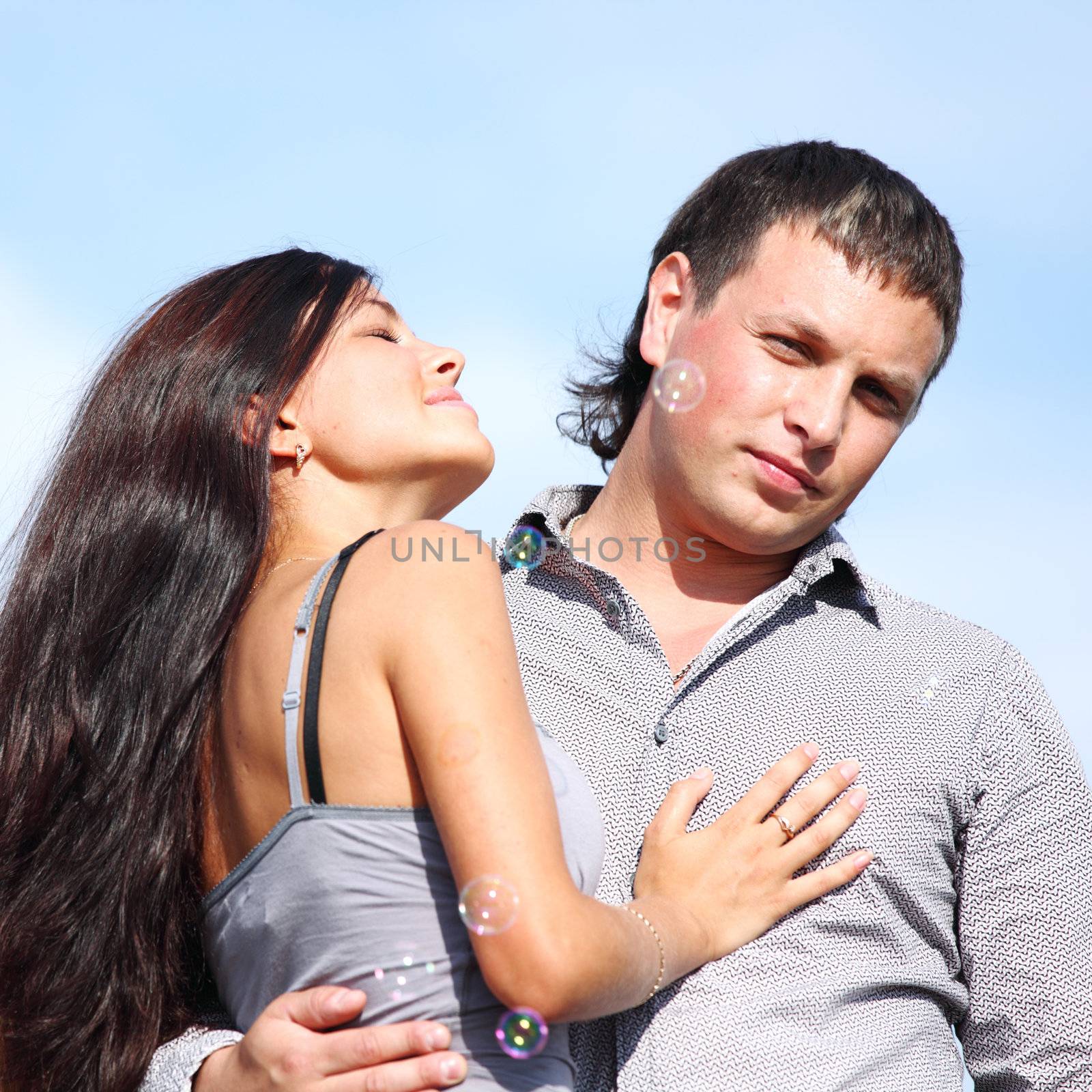 man and woman hug in the sky