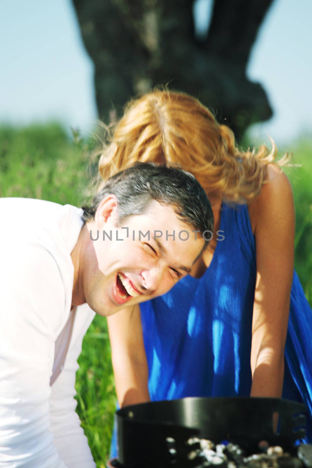 man and woman on picnic in green grass