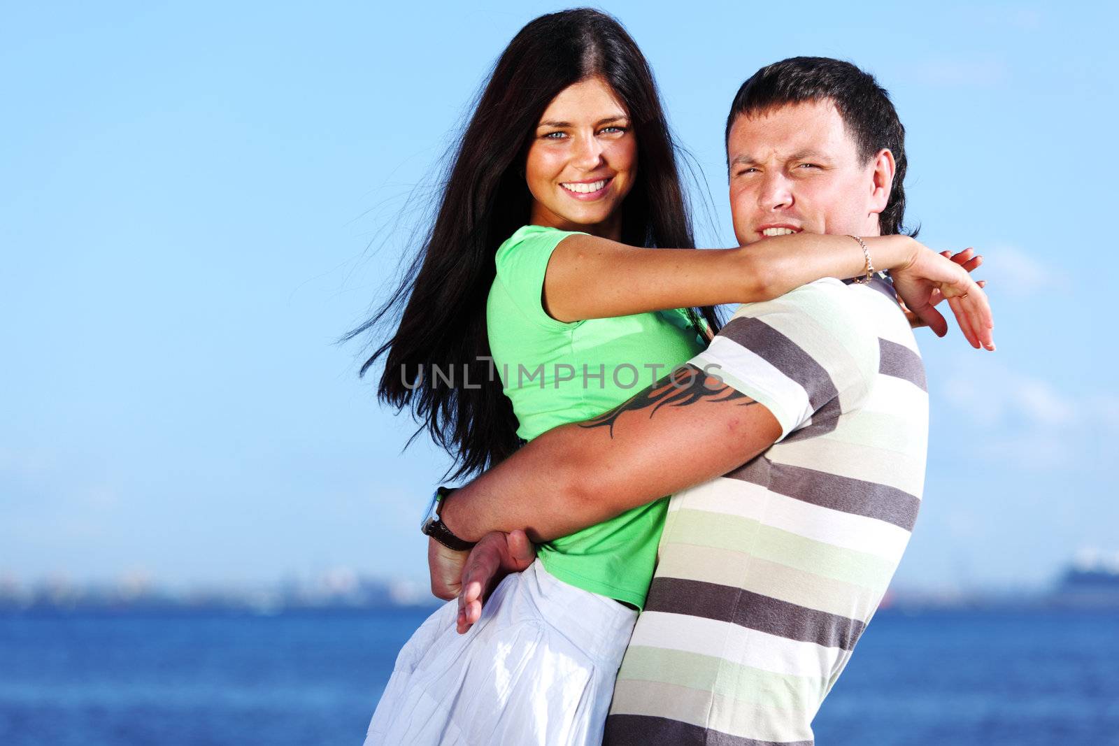 man and woman hug in the sky sea on background