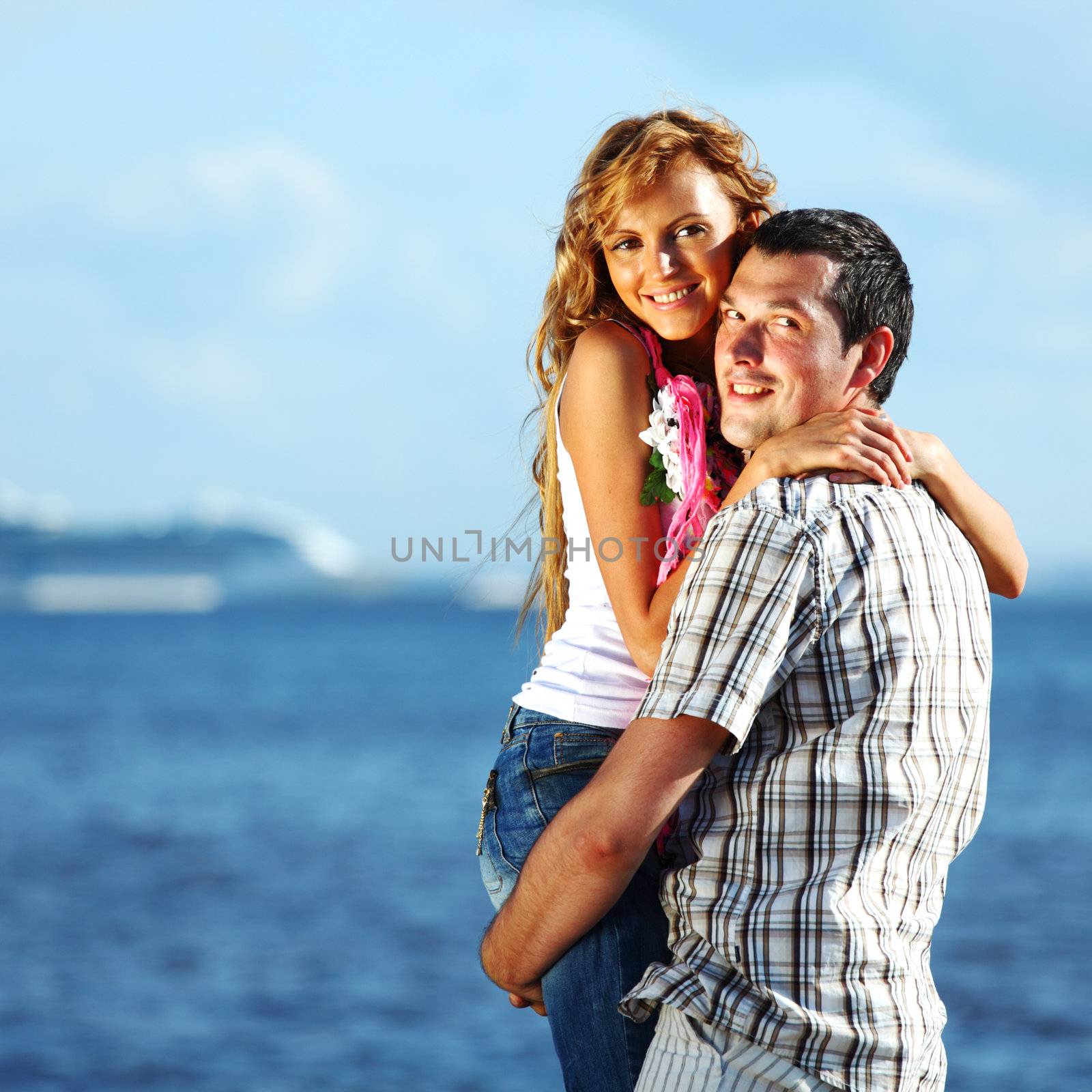 man and woman hug in the sky and sea on sea