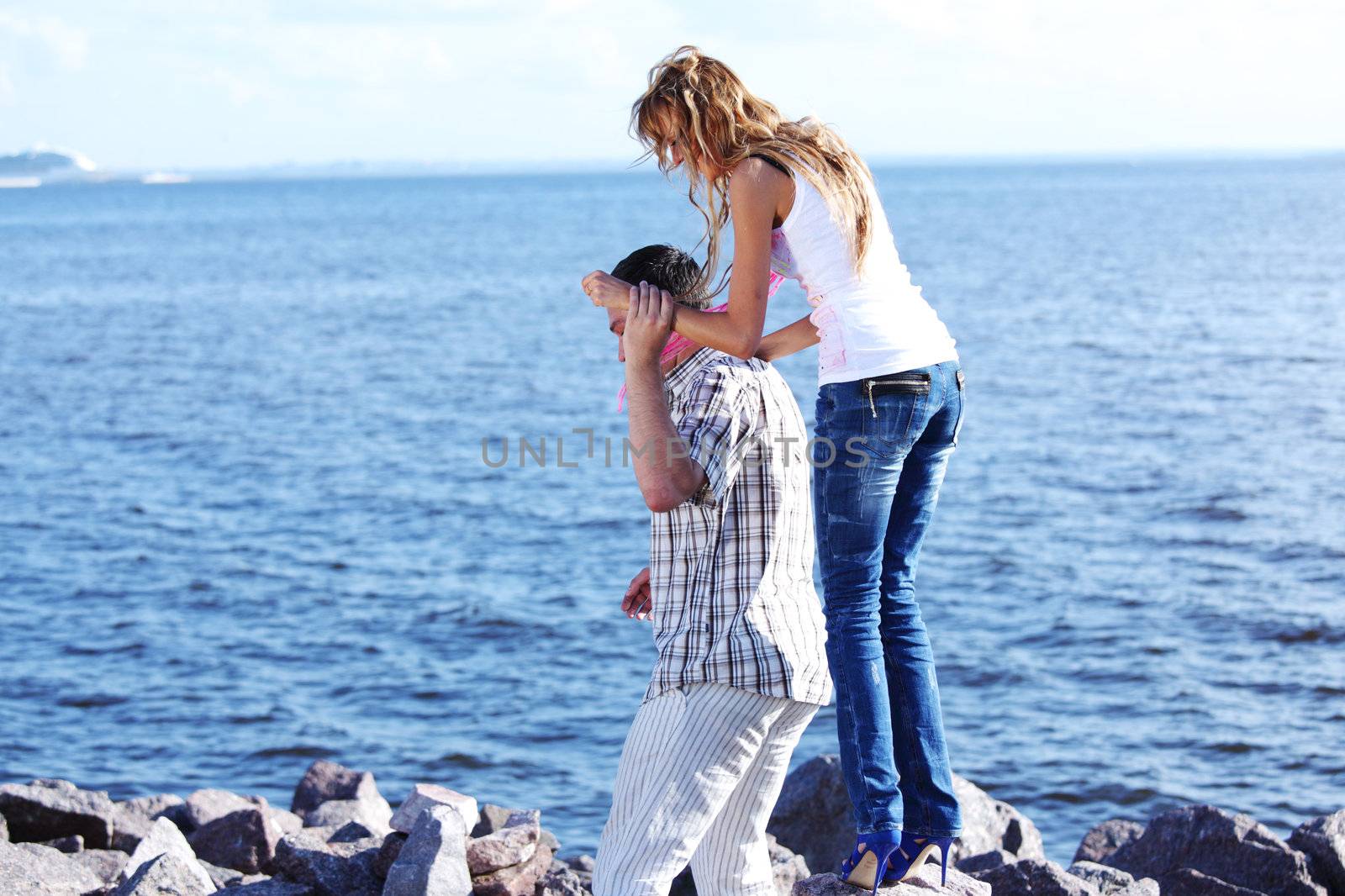 man and woman hug in the sky and sea on sea
